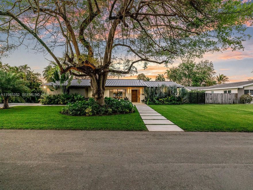 Fully reimagined modern residence on a rare canal-front lot in prime N. Palmetto Bay, minutes from Pinecrest. Set on 14,947 SF with serene waterway views, this 4-bedroom, 3.5-bath home spans over 2,900 SF under AC and was completely transformed in 2025 with designer-level finishes throughout. The open-concept layout is bathed in natural light with architectural details including a floating staircase, skylights, custom millwork, and designer LED lighting. The chef's kitchen features custom cabinetry, a book-matched porcelain waterfall island, Samsung appliances, wine and beverage refrigerators, and Hansgrohe fixtures. The primary suite offers a spa-inspired bath with soaking tub and an oversized, fully built-out walk-in closet. Custom built-ins extend through the kitchen, pantry, bar, closets, and baths delivering both function and artistry. A metal roof, new electrical panel, AV system, and two EV charging outlets complete the package. Outside, a covered wood-ceiling loggia opens to a heated pool and lush lawn along the canal, framed by palms and a clear fence a true private oasis. Near top-rated schools, parks, and the best of Palmetto Bay and Pinecrest.