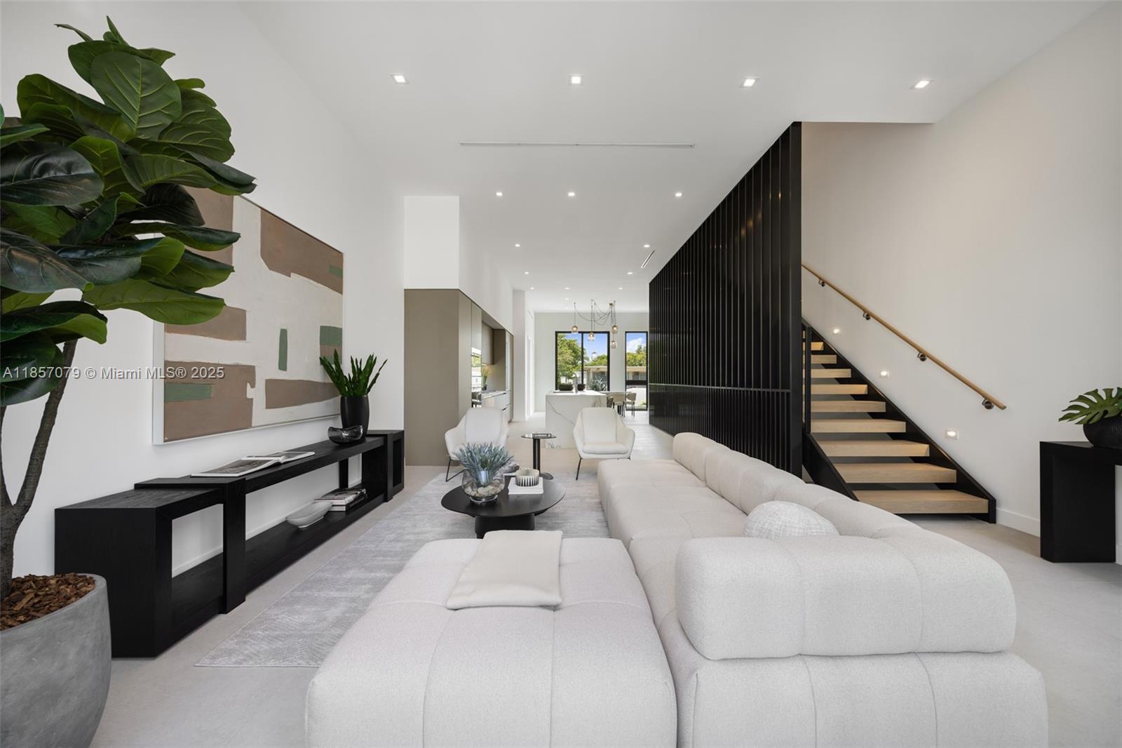 Award-winning contemporary residence in The Roads Townhomes featuring a distinctive formed-concrete façade, private gated courtyard, and Mondrian-inspired privacy screens. A dramatic open stairwell, volume ceilings, and skylight define the airy interior, while the sprawling second-floor living space flows to a 10’ glass-walled terrace. The chef’s kitchen offers European cabinetry, porcelain slab surfaces, Bosch appliances, and a waterfall island with seating for 10+. Spa-style baths include a freestanding tub and dual vanities. Additional highlights: multiple balconies, sound-insulated walls, full-size 2-car garage, and concrete construction with impact glass.
