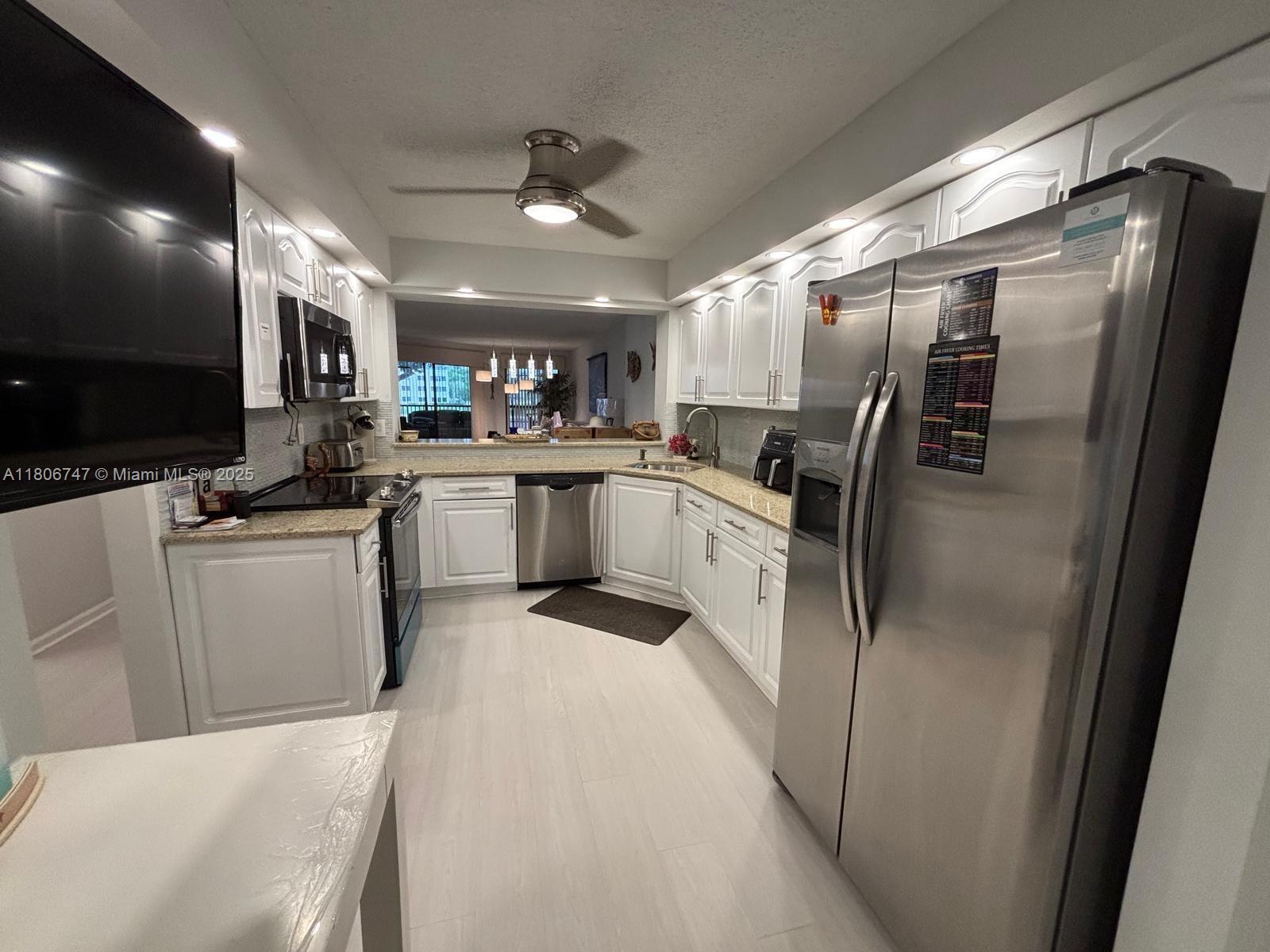 Move-in ready 2BD/2BA lakefront condo in the sought-after 55+ community of Kings Point! This bright and spacious unit features updated flooring, an open-concept layout, a modern kitchen with granite countertops and stainless steel appliances, and a large screened balcony with serene water views. The split floor plan includes a spacious primary suite with dual vanities and a step-in shower, plus a versatile second bedroom with murphy bed. In-unit laundry, ample storage, and resort-style amenities: pools, clubhouse, gym, theater, and courtesy bus. HOA covers cable, internet, water, and more!