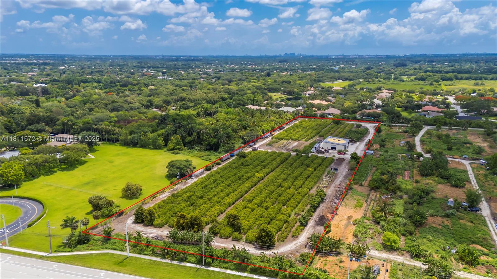 8.9 Acres! Unique property in Davie surrounded by million-dollar homes in a fast-growing, family-friendly area with "A" rated schools. Fronts Flamingo Rd, backs Flamingo Gardens, and borders the gated Ridge at Laurel Oaks. Fully fenced with gated access. Operating tropical fruit grove since 1987 with ~1,000 starfruit trees and other varieties (macadamia, avocado, banana, etc.). Features include a 5" well, advanced irrigation, very low ag taxes, and a 4,800 sf insulated steel building (Cat 5+ rated) with 1,140 sf A/C space, 2 kitchens, 2 baths, and 3 offices. Industrial features: mezzanine, 800A power, racking, security system. Includes prepped 1-acre homesite for a 4,000 sf home. Ideal for family compound, agribusiness, or investment. Agriculturally assessed, very low taxes.