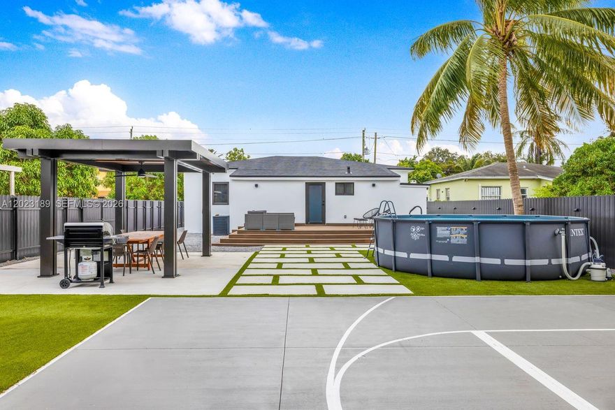 INCOME PRODUCING and fully renovated with permits, this 5-bedroom, 3-bath home is positioned for strong tenant demand, end-user appeal, or immediate investment potential. Just minutes from the Design District, the home offers a spacious, easy-flowing layout designed for everyday living and entertaining. The modern kitchen features black stainless steel appliances, sleek cabinetry, and generous space for gathering. Outdoors, the backyard is built to entertain with an above-ground pool, hot tub, basketball hoop, putting green, and covered dining area with room to grill. With strong monthly revenue and financials available upon request, this turnkey property offers flexibility, lifestyle, and income potential in one of Miami’s fastest-growing pockets.