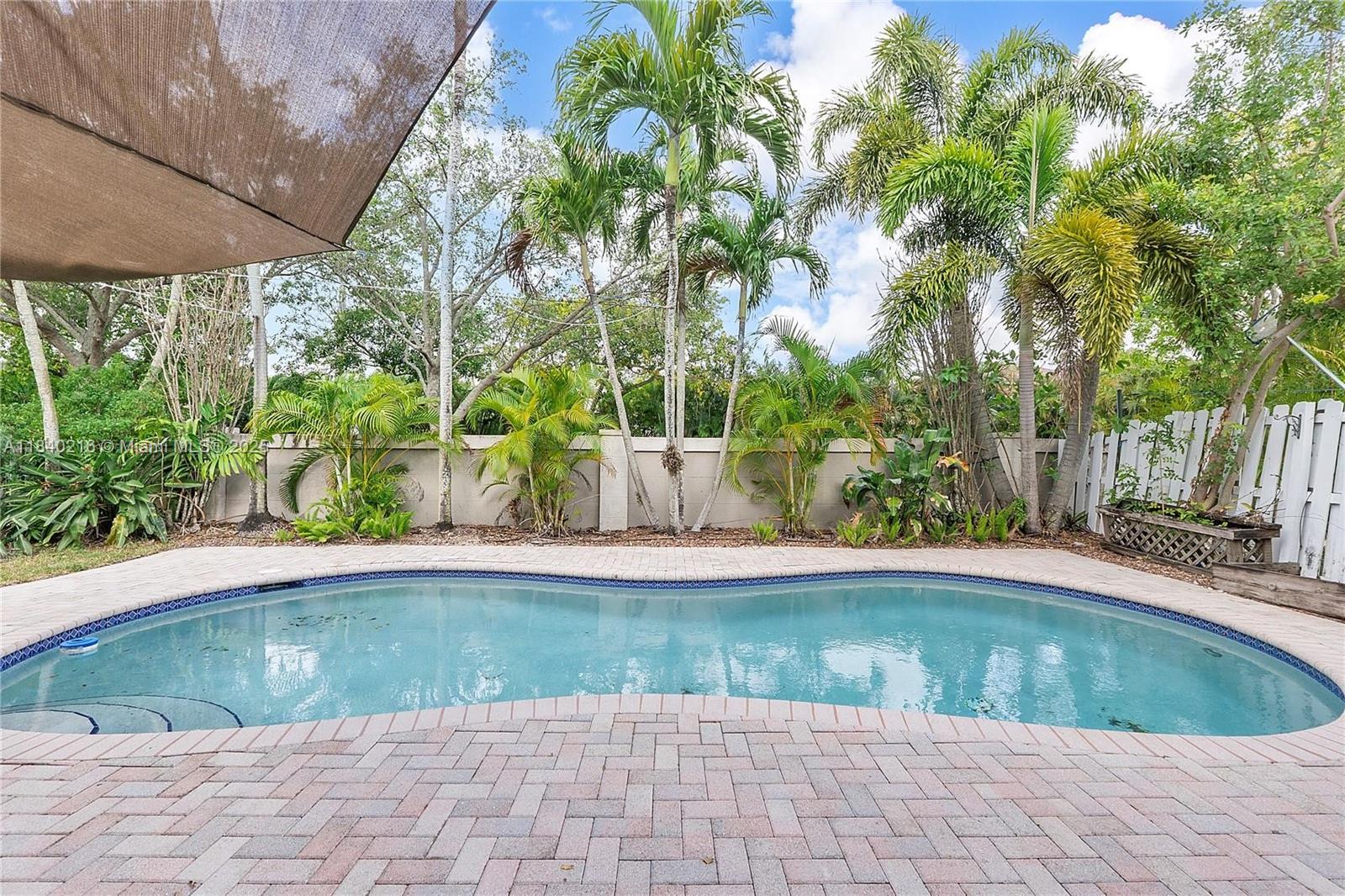 Discover this 3 bed/2 bath charming pool home nestled in the exclusive Banyan Oakridge Gated Community in Hollywood. Offering a spacious, open floor plan with beautiful bamboo flooring throughout, this home is designed for modern living. The updated kitchen features stainless steel appl., a wine cooler and granite countertops. The luxurious master bath boasts travertine finishes, a large frameless glass shower, and a convenient built-in dresser. Step outside to your private backyard oasis, complete with a sparkling pool, ideal for relaxation or hosting gatherings. This home is located within walking distance to worship houses. The community offers security, tennis courts, basketball courts, and playground. Max. 5 residents - Also for lease MLS #A11799619