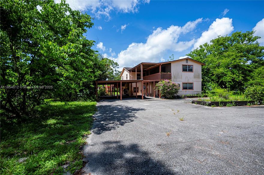 This large 5 bedroom/3 bath home is ideally situated on a beautiful tract of land (2.5 acres) in Pioneer Plantation and really has so much to offer. The two-story home is the true centerpiece of the nicely landscaped property, which is completely fenced, providing an ideal setting and the space required for a pool and patio as well as the privacy so many families value today. The private, paved driveway leads from the road to a unique home that boasts not one but TWO master suites, both complete with ensuites and roomy closets. Other features include a large screened-in lanai on the first floor as well as an elevated balcony on the second floor - perfect for enjoying the picturesque views afforded by both. A spacious living and dining area is adjacent to the kitchen downstairs.