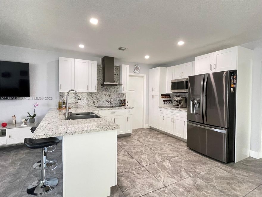 COME HOME to this fully renovated tropical oasis just 3 miles from SoFlo’s Beach! CONTEMPORARY tones, LED fixtures, modern baseboards & dual shade blinds greet you in an open floor plan. The STYLISH kitchen boasts granite counters, Profile range hood, shaker cabinets & eat-in counter. Well-portioned Master w/walk-in closet, designer bath & rain showerhead. Spacious laundry & storage rooms. Enjoy savings of natural GAS dryer/water heater, all IMPACT windows/doors, NEW 2021 Roof/AC. Unwind outdoors in Pool & covered Patio. This fully fenced CORNER LOT w/NO HOA & extra wide gates make it easy to park RV/Boat. The property is minutes from ENDLESS CHOICES of shops/dining/parks/Casino/Mall/I-95/FLL/MIA. Many other features…Must see to fully appreciate! Book appt NOW!