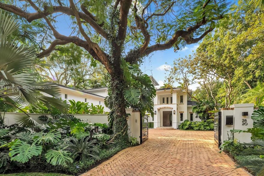 LOCATION LOCATION LOCATION!!! Minutes to Coconut Grove, Brickell, the Design District and MIA this magnificent 8,881 SF residence on a 20,000 SF gated lot is ideally located close to all the best of Miami. The 6-BD, 6.5-BA home blends luxury and comfort, with a bright and airy ambiance, volume ceilings and abundant natural light. The chef's kitchen features an expansive island, top tier appliances, quartz countertops, and custom cabinetry. Upstairs, enjoy hardwood floors and French marble baths. The outdoor area is an entertainer's dream, with a summer kitchen, and heated pool/jacuzzi surrounded by lush landscaping. A Chicago brick driveway, a 4-car garage and a car lift provide ample parking. Other features include a wine cellar, impact windows/doors, and interior/exterior audio system.