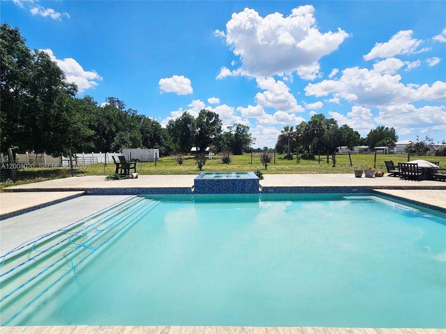 FABULOUS 5-ACRE PROPERTY SECULDED AT THE END OF A ROAD WITH SEPERATE 2-BED/1-BTH IN-LAW QUARTERS (KITCHEN / LIVING ROOM & DINING ROOM) CURRENTLY RENTED MTH-TO MTH @ $1300.
MAIN HOUSE IS 2 STORY WITH 5-BEDROOMS / 5.5-BATHS.  HOME FEATURES 2 MASTER SUITES (1 DOWNSTAIRS); 2-BEDROOMS WITH "JACK & JILL" FULL BATH, 2-OTHER BEDROOMS EACH WITH PRIVATE BATHS (1 BEING A HUGE CABANA BATH) AND A HALF BATH DOWNSTAIRS. LARGE FAMILY ROOM W/ FIREPLACE; LARGE OPEN KITCHEN (UPDATED IN 2021) WITH AN ISLAND THAT CAN FIT UP TO 12- PEOPLE; FORMAL LIVING ROOM AND / OR DINING ROOM AREA; FLORIDA ROOM WITH PRIVATE ENTRANCE COULD BE ANOTHER BEDROOM, DEN OR OFFICE; HUGE LAUNDRY ROOM AREA; 4 CAR CARPORT; POOL-HEATED (4-FT DEEP ALL AROUND) / SPA-HEATED WITH CONCRETE DECKING; 4-FT FENCE AROUND POOL AREA; IMPACT WINDOWS THROUGH-OUT (EXCEPT FOR 2 SMALL WINDOWS); 2-ON DEMAND WATER HEATERS; SOLAR PANELS (CAN STAY OR BE REMOVED); 3-WELLS; 2-A/C UNITS; OAK TREES AND VARIETY OF PLANTS. PERFECT HOME FOR A GROWING FAMILY; SHARED HOUSING OR RENTAL.  **PLEASE INQUIRE ABOUT ITEMS THAT WILL NOT CONVEY** ALL INFORMATION PROVIDED SEEMS TO BE ACCURATE BUT SHOULD BE VERIFIED BY BUYER AND OR BUYERS AGENT.
