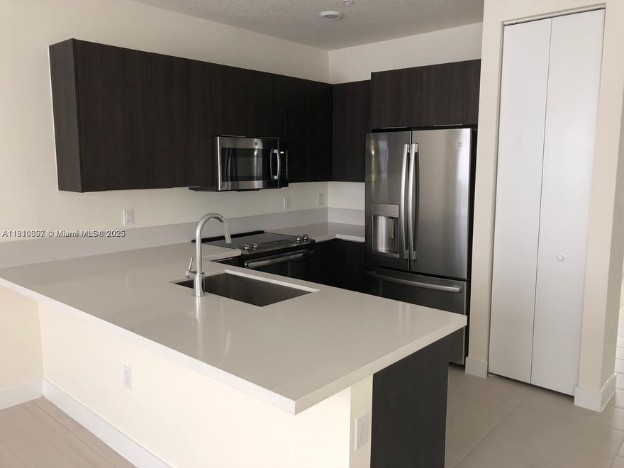 Beautiful modern condo in Landmark at Doral. This 3 bedroom 2 bathroom unit has an open area with kitchen, living and dining perfect for entertaining. The modern kitchen features a deluxe stainless steel appliance package and quartz countertop. Walk in closets and master bathroom with dual sink and large shower are very spacious. The home is equipped with the most up to date technology, Wi-Fi ready. The community offers resort style amenities, with tennis courts, pool, and gym. Near great schools, restaurants and entertainment spots.