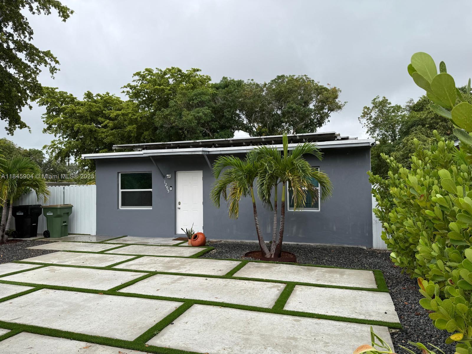 Updated single family home situated on a gated corner lot in a quiet North Miam neighborhood. This home features 2 bedrooms, 2 updated bathrooms and a modern kitchen. Enjoy the outdoors with an exterior kitchen and a generous side yard, ideal for entertaining or relaxing. Washer and dryer included.