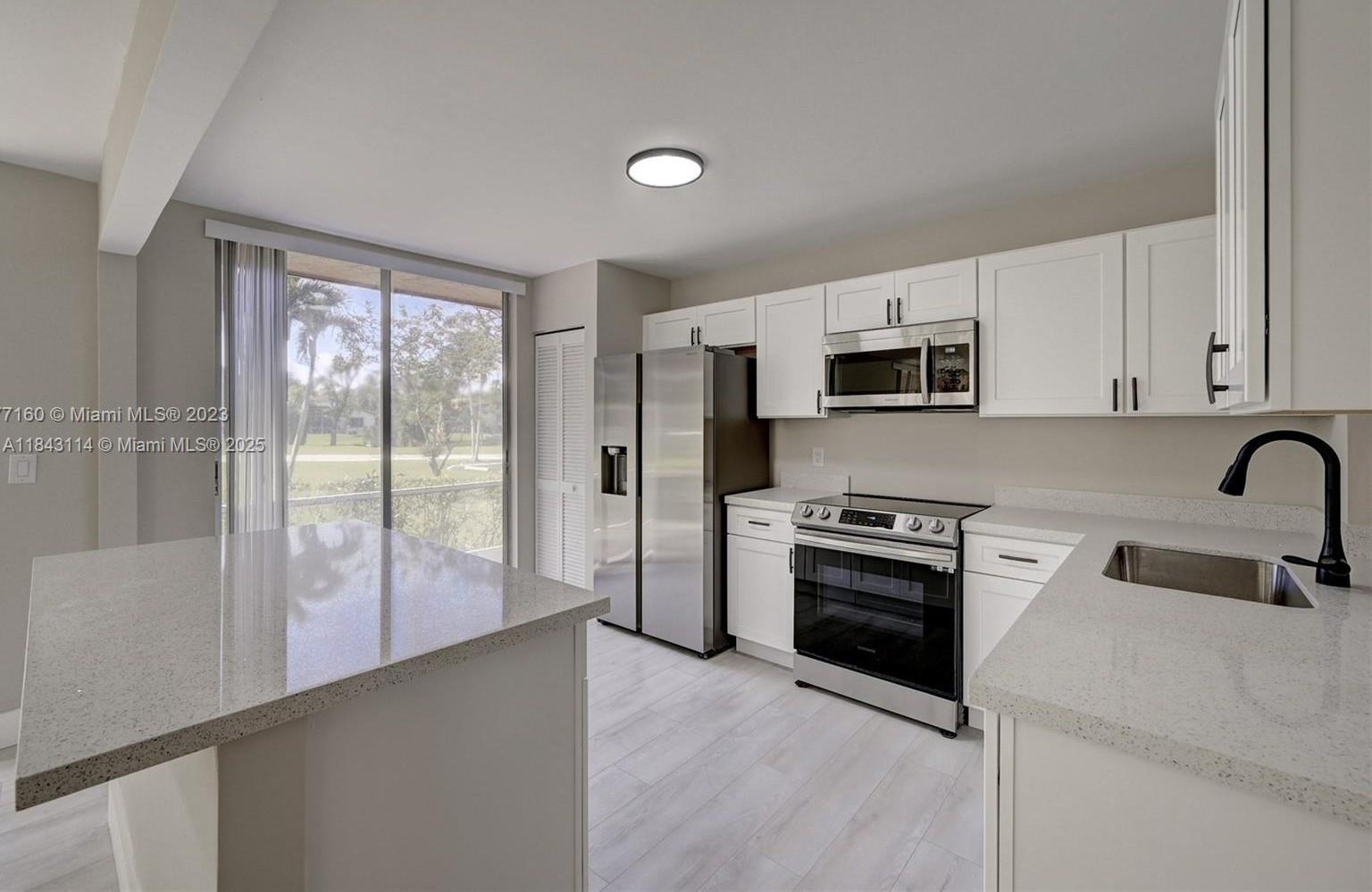 1st FLOOR, 3/2 condo, Updated Spacious Corner unit, Open layout with Golf course view, lots of natural light, Water Proof Flooring, modern baseboards, white shaker-style kitchen cabinets w/new hardware, stainless steel appliances, slide-in range, Quartz Kitchen Counter tops with Island, Master walk-in closet, frameless shower glass in guest bath, porcelain tile in both bathrooms, 2 Vanities w/Quartz counter tops, newer A/C, newer water heater, new washer & dryer, new bath fixtures, Expansive patio screen in patio w/roll down shutters throughout, storage room, lots of guest parking/dedicated parking spaces for unit. Owner Occupied community! Maintenance includes Roof Repairs, Ins., Water, Cable & more. Centrally located near I75, BB & T center, shops, entertainment and restaurants.