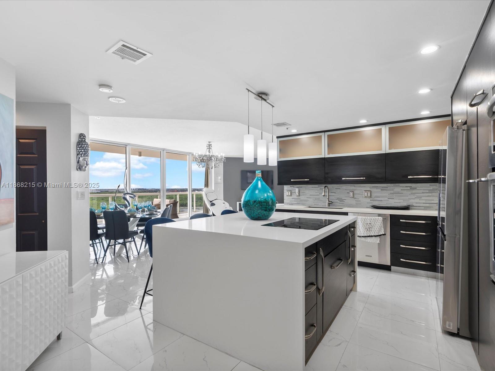 This 12th-floor, 2-bedroom, 2.5-bath condo at Renaissance on the Ocean offers 1,800 sq. ft. of open living space with stunning west-facing sunset and city views. The chef-inspired kitchen features custom wood cabinetry, pull-out pantry shelving, a quartz island, and built-in induction cooktop. Spacious living and dining areas flow to a private balcony, while the primary suite includes ample closets and a spa-like bath. Residents enjoy direct beach access, oceanfront pools, tennis courts, fitness center, spa, concierge, valet, and 24-hour security.