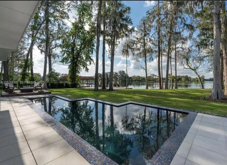 Enjoy the best of what luxurious lakefront living has to offer in this stylish, modern, smart new home in Winter Park's exclusive Via's neighbourhood. This spectacular, 5-bedroom, 6.5-bath, multi-level masterpiece combines innovative contemporary design with brilliant architectural artistry, blending the latest in modern living with superior craftsmanship. Tucked away on Lake Maitland adjacent to the Isle of Sicily, this exquisite home features state-of-the-art technology throughout, accented by classic, elegant finishes such as custom Walnut floors, staircase, landing and interior doors, and porcelain tile work. Designed for lakefront living and entertaining inside and out, a large designer chefs kitchen includes custom cabinetry, dual dishwashers, double ovens, warming drawers, a large walk in pantry and wet bar with wine cooler. Step outside to enjoy gorgeous views of the largest lake in Winter Park's chain, and outdoor lanai including a sparkling pool, an outdoor kitchen, a gas fire pit and outdoor shower. The first floor includes a large master suite, 2 additional bedrooms, and a formal dining room. glass-enclosed office, and gas fireplace. The second floor includes a den and two bedrooms with full baths. This modern Smart Home is iPad & Touch Panel integrated, including surround audio, lighting control, video doorbell with off-site answering, garage door control, voice control, retractable phantom lanai and patio screens