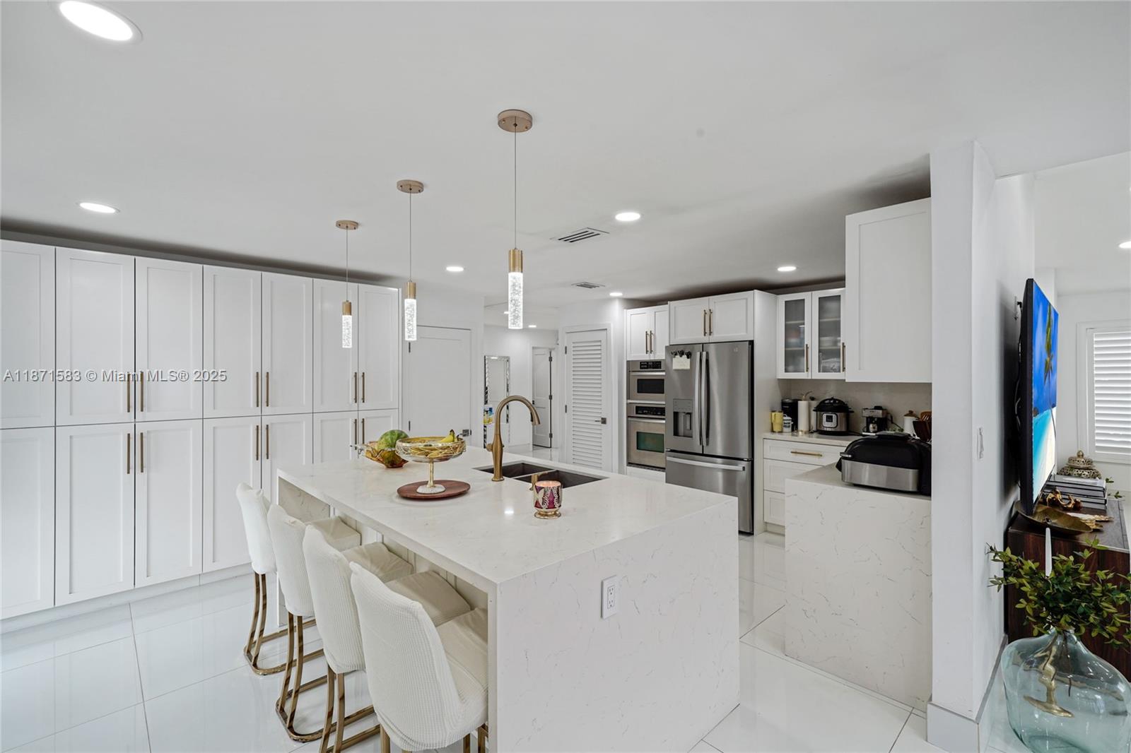 Fully remodeled Mar-2023. 3BD/2BA in Les Chalets II with large-format premium Turkish porcelain floors (inside & patio), recessed LED. Chef’s kitchen: solid-wood cabinetry with aluminum/glass accents and full-extension pull-outs/organizers—no fixed shelves. Spa-style baths w/ frameless glass & rainfall panel. Primary suite opens to patio; custom walk-in + coffee/wet bar. Expansive covered terrace + tiled yard and gazebo/summer kitchen. Concrete barrel-tile roof ~2015–16 (per seller); A/C ~2021–22 (per seller). Vinyl fence, oversized stamped driveway. Near FIU, Turnpike & 836.
