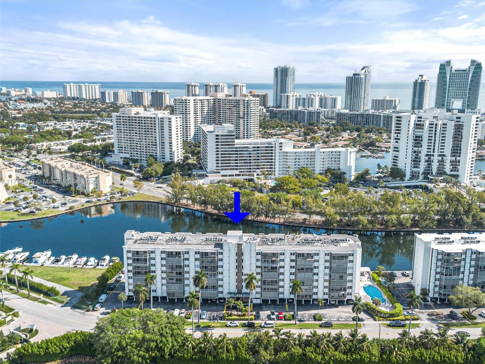 Top-Floor End Unit Penthouse - Prime Location just steps from the beach. Enjoy panoramic water views from every room, framed by lush palms. Both bedrooms offer stunning views of the prestigious Yacht, Tennis and Golf Club. With abundant natural light, a beachy modern design and prime location just steps from the beach, this condo provides the ultimate relaxed yet sophisticated living experience. Features new impact windows and doors, fresh paint and modern finishes throughout. Open concept Penthouse showcasing solid wood cabinetry, updated plumbing and HVAC just 5 years old. This unit features a large screened balcony offering ultimate privacy and tranquility. 2 pools, gym, game room and sauna. Large closets and extra storage rooms. Enjoy the coastal lifestyle in a beautiful bright space