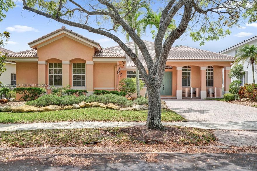 Versatile Dove model in one the the most exclusive Subdivisions in the guard gated Savanna, one of Weston’s most sought after resort style communities. This one story 4 bedroom, 2.5 bath home offers an open concept layout is perfect for entertaining with high ceilings, crown molding, and abundant natural light. Lushly landscaped, quaint front porch, excellent curb appeal, and side entry two car garage create an inviting first impression. The spacious updated kitchen features granite countertops, a large center island with seating, separate breakfast area, built in bar, desk space, and generous cabinetry. The oversized covered and screened patio extends the living space outdoors, ideal for entertaining and everyday relaxation. Room for a pool.  The primary suite features volume ceilings and organized closet space. Tile flooring runs throughout the main living areas, with laminate wood flooring in the bedrooms. Two remodeled showers add a fresh modern touch. A separate laundry room leads to the garage, offering additional storage. Extended papered driveway, situated right next to a huge park to enjoy your favorite sports!  Enjoy access to A+ schools and Savanna’s exceptional amenities, including resort style pools, fitness center, water slide, playgrounds, and more