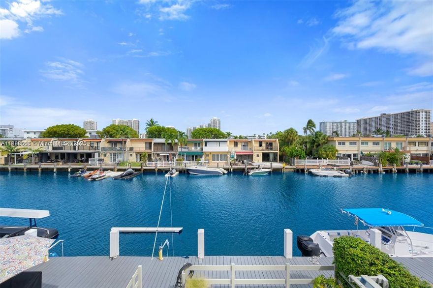 Discover the perfect Townhome in Eastern Shores, close to all the excitement—beaches, shopping, dining, and more. This spacious 3-bedroom, 3-bathroom townhome, completely renovated, is nestled on a peaceful, tree-lined street. Enjoy a stunning patio/deck on the canal with 30' private dock for your boat included, Ocean access no bridges, ideal for entertaining guests. The home boasts high ceilings, porcelain flooring, impact-resistant windows and doors. The Italian-designed kitchen and bathrooms feature high-end appliances and quartz countertops, along with a convenient washer and dryer. The HOA covers insurance, water, trash, and maintenance. With only 12 townhomes in this unique community, gated and 24 hours guarded. 2 parking spaces. This property is vacant and easy to show.