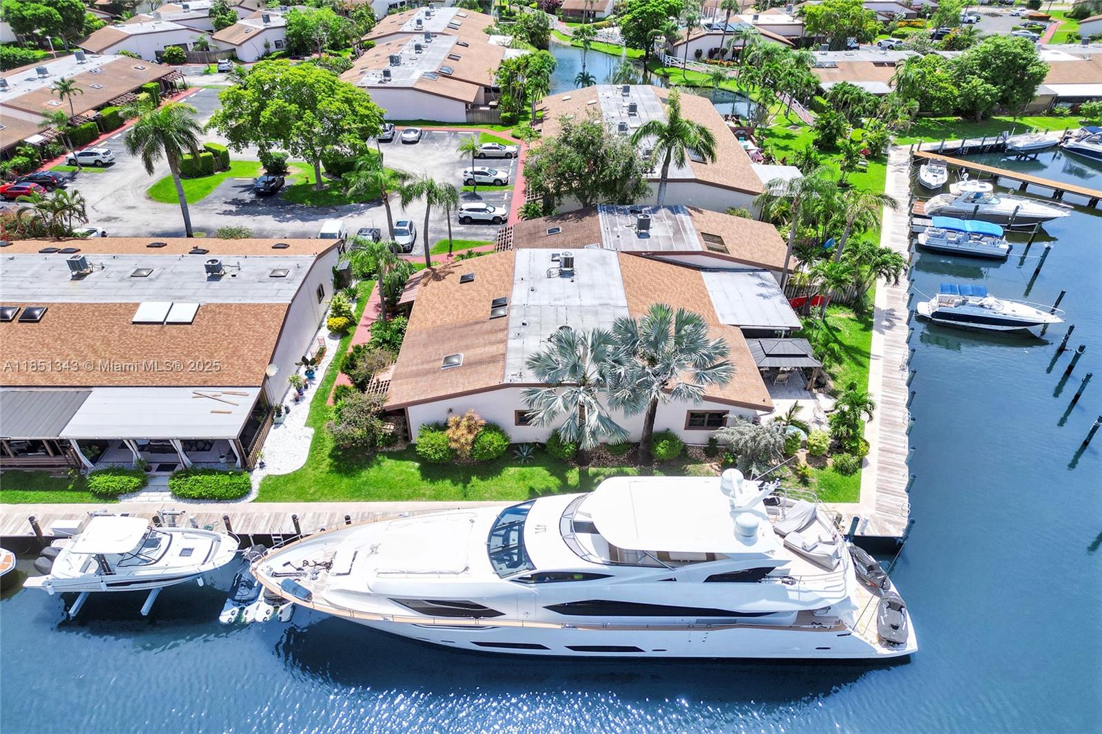 ATTENTION BOATERS!!! This corner waterfront villa is the jewel of the community in Harbourwood Villas. No other residence offers this much dock space, 136 feet, to be exact. Your private L-shaped dock has 94 feet on one side and 42 feet on the other side. Enough space to accommodate multiple boats, and boat lift is included. Outside, the property boasts a private waterfront patio, built-in jacuzzi, and gazebo. The fully furnished open layout creates a seamless flow between the living, dining, and kitchen areas, making it ideal for entertaining friends or simply unwinding after a day on the water.