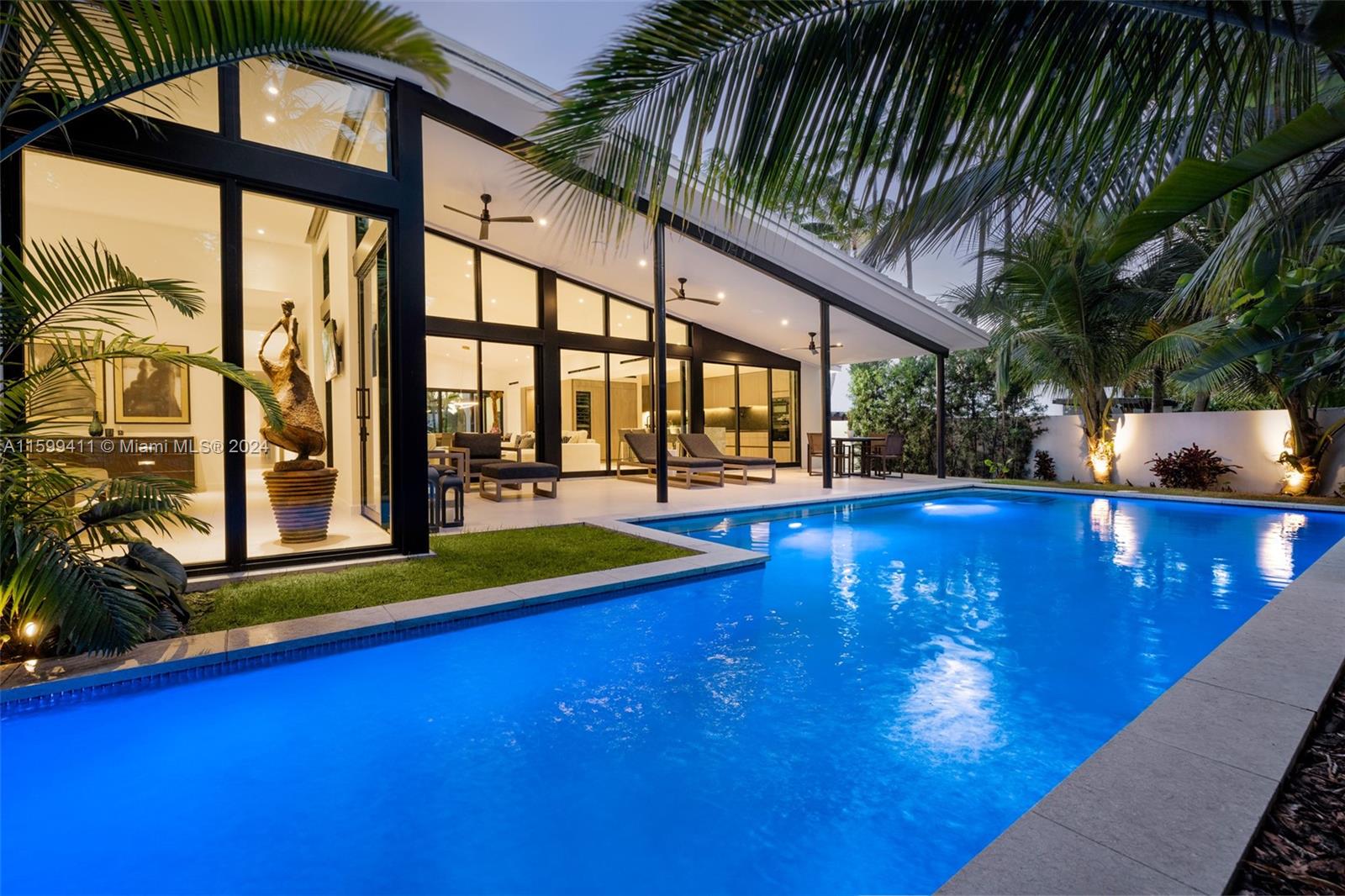 Welcome to your Mid-Century Modern masterpiece where timeless elegance meets contemporary luxury. Completed in 2022, this architectural beauty boasts features that redefine modern living. A seamless fusion of indoor-outdoor living, stunning floor-to-ceiling glass doors connect the interior to the patio & lush tropical retreat with a sparkling pool and a cascading waterfall.
This meticulously designed residence offers 4 bedrooms and 3 bathrooms, every detail has been carefully curated to reflect sophistication and style, from the Italian flooring to the leathered granite counters and terrazzo marble island.