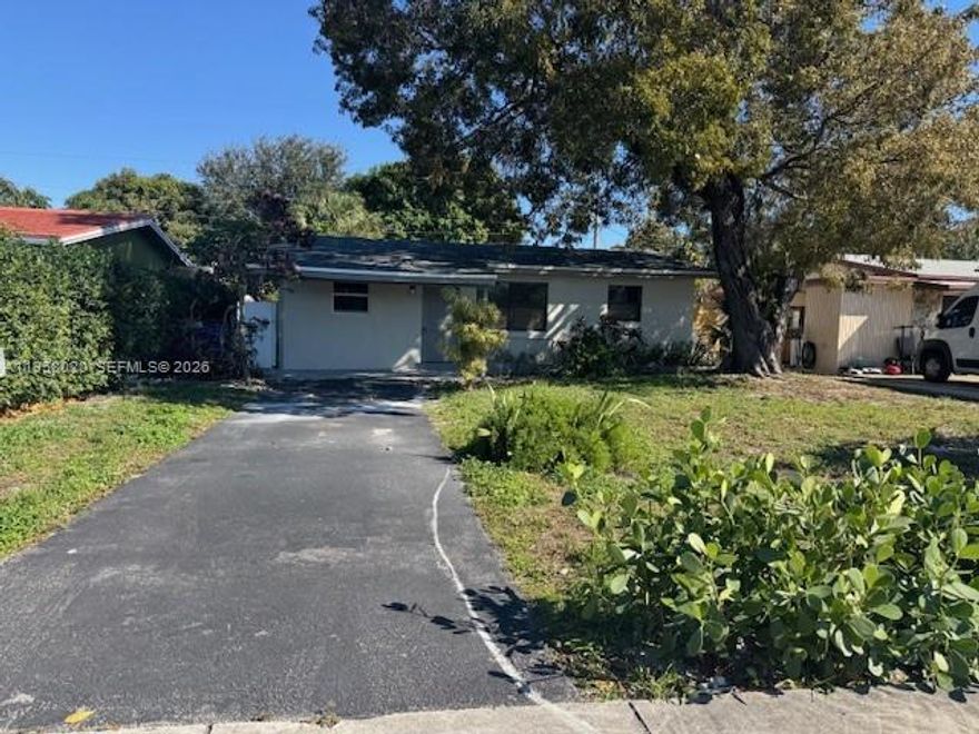 The 4 bedroom 2 full baths with den over 1400 sq feet a must see and is ready to move in with new roof and windows - updated baths and kitchen - - close to shopping and buses - 20 minute to beach -