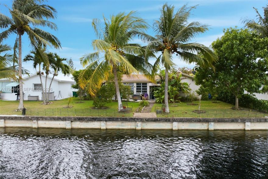 Welcome to your own slice of paradise in this waterfront, move-in ready 2-bedroom, 3-bath home located in a desirable 55+ community. Thoughtfully updated, this home offers the perfect blend of comfort, style, and relaxed Florida living.  Inside discover new tile flooring throughout and an updated kitchen with brand-new appliances, making everyday living both easy and elegant. The light-filled sunroom invites you to unwind while enjoying peaceful water views, creating the perfect space for morning coffee or evening relaxation. Outside, you’ll love the lush surroundings with an incredible variety of mature fruit trees—including banana, avocado, mango, guanabana, passion fruit, lemon, and more—bringing a true tropical feel right to your backyard. Impact windows provide added peace of mind, while the many recent updates make this home truly turnkey. Residents enjoy access to a community pool and clubhouse, offering wonderful opportunities to connect, relax, and enjoy an active lifestyle. This waterfront gem is ready to welcome its next owner—come experience the comfort, beauty, and easy living that await you here.