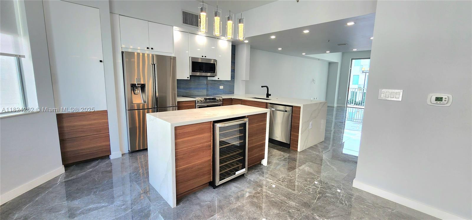 Luxurious modern 4-Bedroom 3.5-Bathroom fully renovated townhome with upgraded features and finishes and 2-car garage in the heart of Downtown Hollywood! Walking distance to restaurants, bars, supermarket, pharmacy, and recreational parks. Minutes away from beaches, Ft. Lauderdale Airport, and Hard Rock Casino. Living area includes spacious private balcony, remote control shades, half bath with washer/dryer, and a kitchen featuring wine cooling, formal dining, and stainless steel appliances. Entry level/first floor bedroom. Third floor boasts three bedrooms. Master suite features a secondary private balcony, two walk-in closets, double vanity, separate shower and whirlpool bathtub.