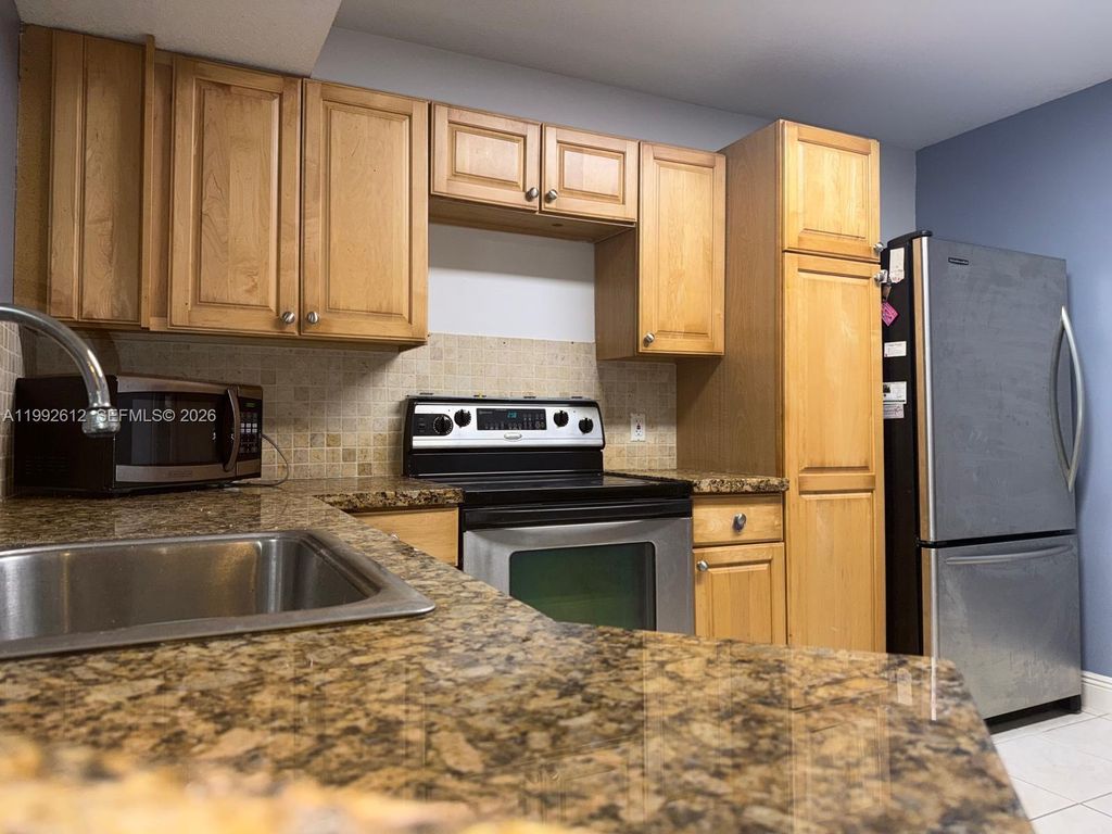 Photo of 8901 Wiles Rd #103, Coral Springs, FL 33067 (MLS # A11992612)