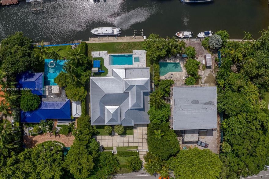 Spectacular home built in 2017 in N. Coconut Grove, w/ 100 ft water frontage & direct access to Biscayne Bay. Formal entry w/ 18ft soaring volume ceilings open to expansive living & dining rm. Fantastic kitchen w/ gas range, eat-in snack bar. Split bdrm floorplan. Phenomenal primary suite w/ office, spa-like bath w/ glass enclosed shower, soaking tub & custom-built walk-in closet. Unique 5th ensuite bdrm upstairs, currently used as an entertaining space, leads to the partially covered balcony; a great spot to catch a sunrise.  Gorgeous backyard w/ covered patio, summer kitchen w/ wine cooler, mini fridge. Heated pool, spa & playground, plus outdoor shower, sauna & cold plunge. Dock space for a 60ft boat w/ 15,000lb lift. Gated drive with architectural pavers, 2 car carport w/ fitness area.