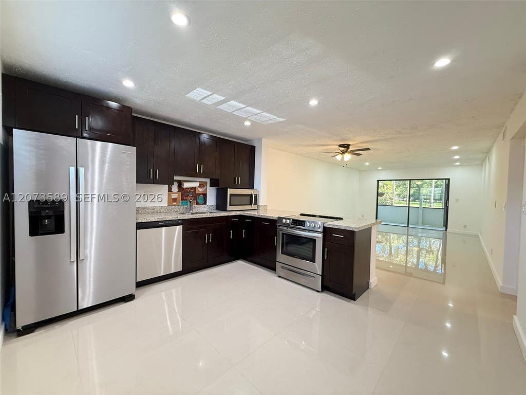 Photo of 6095 N Sabal Palm Blvd #103, Tamarac, FL 33319 (MLS # A12073589)