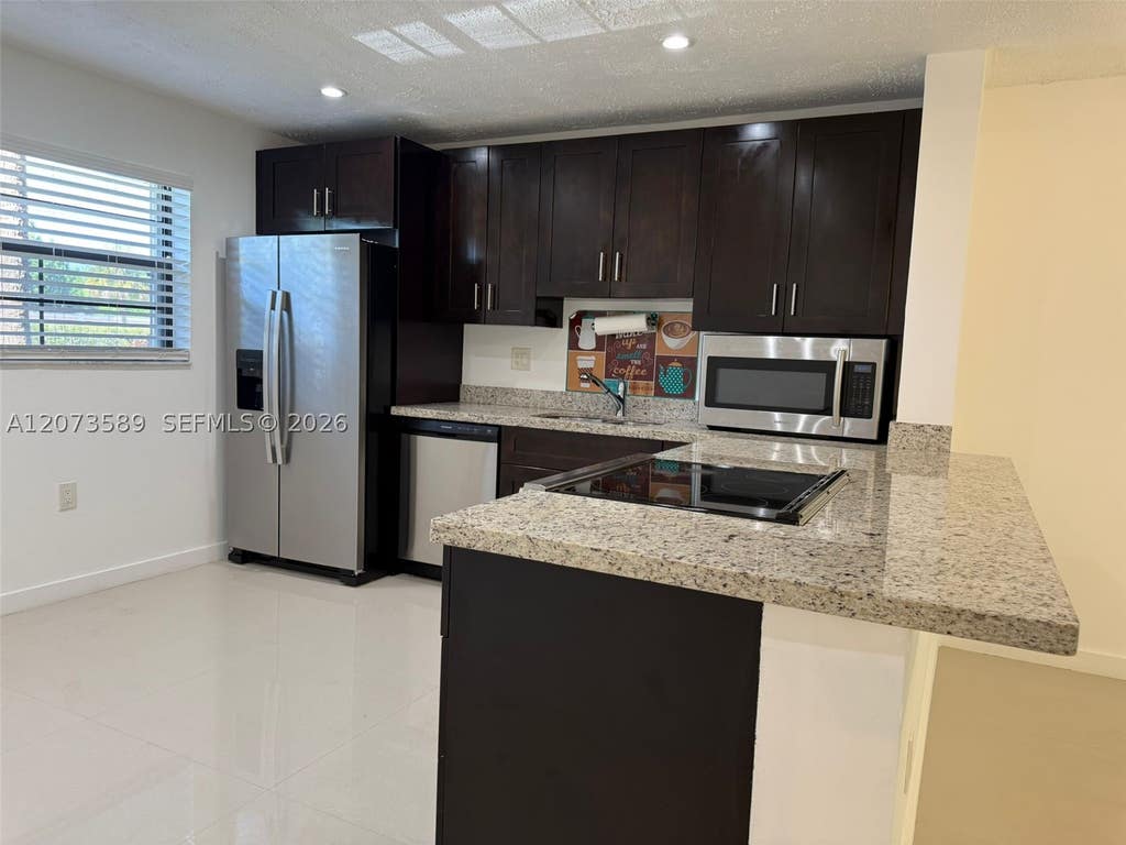 Photo of 6095 N Sabal Palm Blvd #103, Tamarac, FL 33319 (MLS # A12073589)