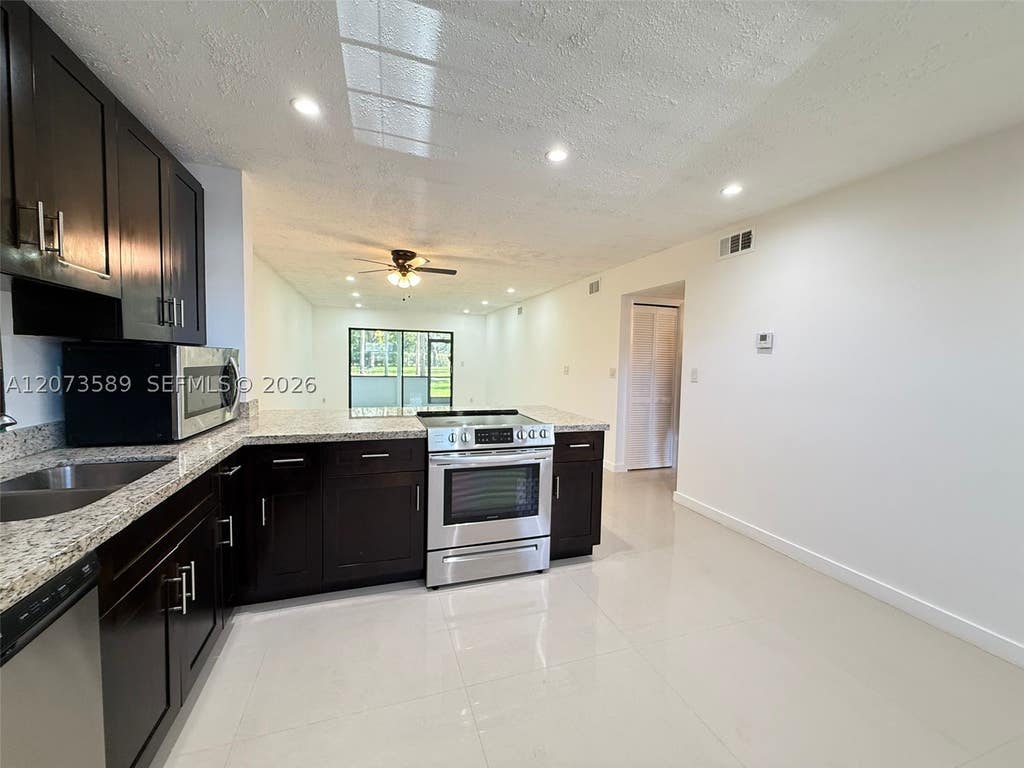 Photo of 6095 N Sabal Palm Blvd #103, Tamarac, FL 33319 (MLS # A12073589)