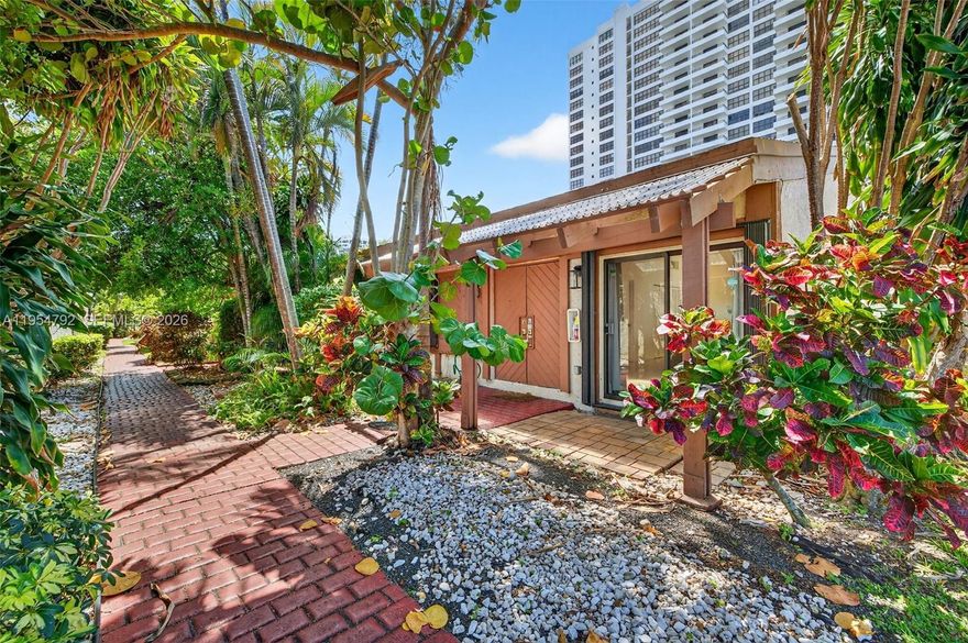 Truly one-of-a-kind and rarely available, this remodeled 3-bedroom waterfront corner home in the coveted Harbourwood enclave of Three Islands offers a unique coastal lifestyle with 33 feet of deeded dock directly in your backyard. Ideally positioned on Parkview Drive with easy access to Three Islands Blvd. Boating enthusiasts: step from your living room straight to the boat and cruise toward open water whenever the mood strikes! This seldom-available floor plan is highlighted by a rare in-house lanai—an exceptional architectural feature that floods the interior with natural light while creating a seamless indoor-outdoor flow. Soaring vaulted ceilings and expansive windows enhance the bright, airy ambiance, complementing the open-concept layout. The beautifully renovated kitchen anchors the main living area with sleek custom cabinetry, premium countertops, and a clean, contemporary design that blends sophistication with everyday comfort. Updated modern bathrooms and cohesive finishes complete the polished interior. An expansive waterfront deck extends the living space outdoors, perfect for alfresco dining and entertaining with tranquil water views. As a prime corner home, it enjoys added privacy, extra green space, and a more open feel within the community. Located just minutes from beaches, fine dining, shopping, and Gulfstream Park, this residence offers the rare opportunity to enjoy private waterfront living in one of Hallandale Beach’s most desirable neighborhoods.