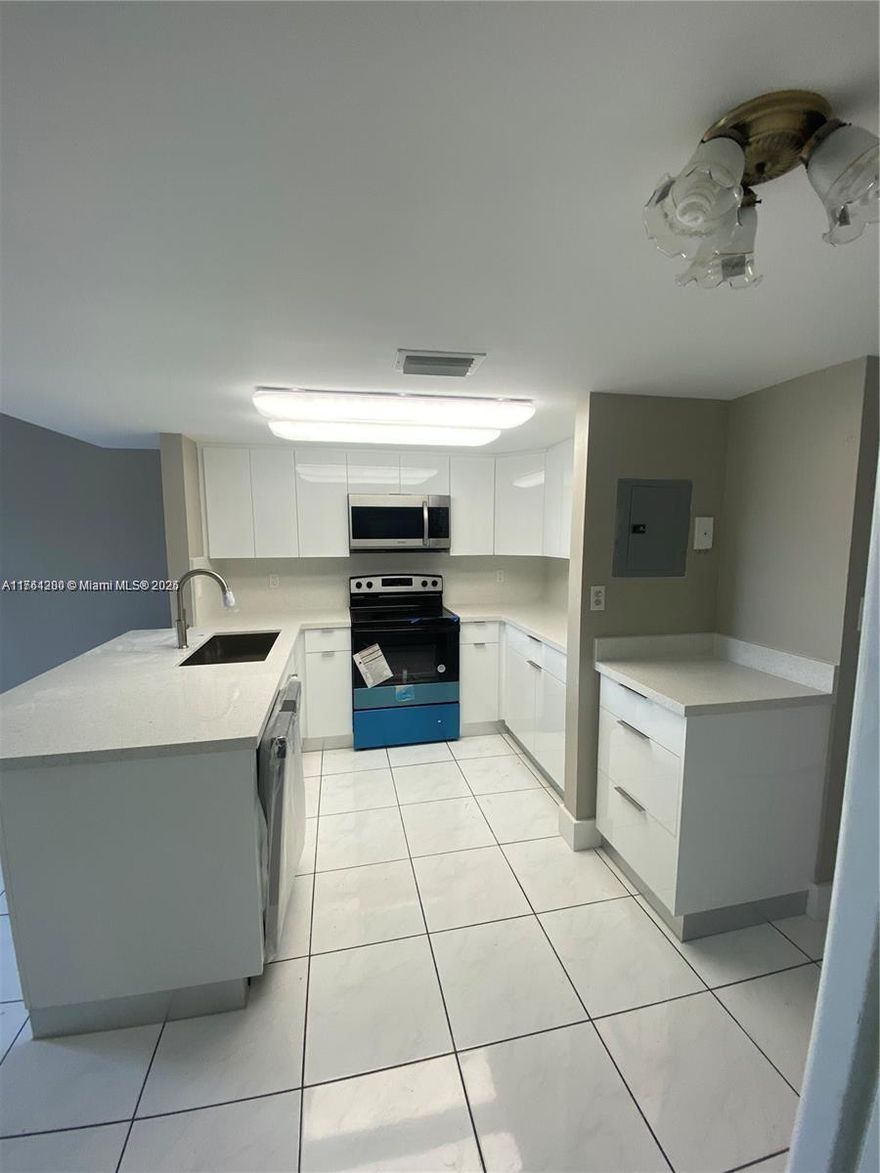 Rare opportunity, Seller will OWNER FINANCE with 20% DOWN! Rented for $2,750! Newly renovated corner 3 bed/2 bath condo in Fern Isle Gardens. This two-story unit is in a prime location & includes a designated parking space right in front, with ample guest parking available. Kitchen features quartz countertops and S/S appliances. Low association dues, ($350 per month) this condo is an excellent option for both residents and investors. Previously leased for $3,100 per month, offering strong rental income potential. The open-concept first floor provides a spacious layout with beautiful city skyline views. Generously sized bedrooms with ample closet space. In unit washer and dryer, elegant oak stairs, accordion shutters, & access to a community picnic area. Seller financing.