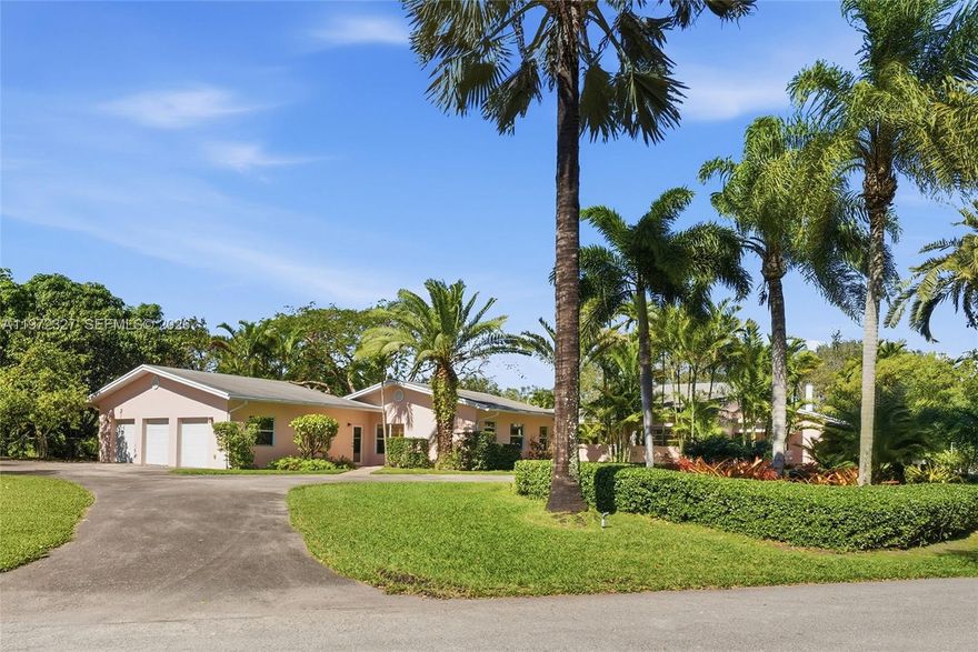 Tucked away on a quiet stretch of SW 92nd Court in the sought-after Baptist/Killian neighborhood, this rare nearly one-acre property offers the space, privacy, and natural beauty that define true South Florida living. Framed by mature palms and tropical fruit trees, the park-like grounds create a serene backdrop for a residence rich in character and possibility. The home features four bedrooms, four bathrooms, multiple living areas, a fireplace, and impact-rated French doors that open effortlessly to the outdoors. A dedicated office connects to a versatile recreation or family room with its own private patio, while a three-car garage and sweeping circular driveway provide both convenience and presence. Located in unincorporated Miami-Dade County, the property also offers flexibility for future enhancements, all within close proximity to top-rated schools, shopping, and dining.