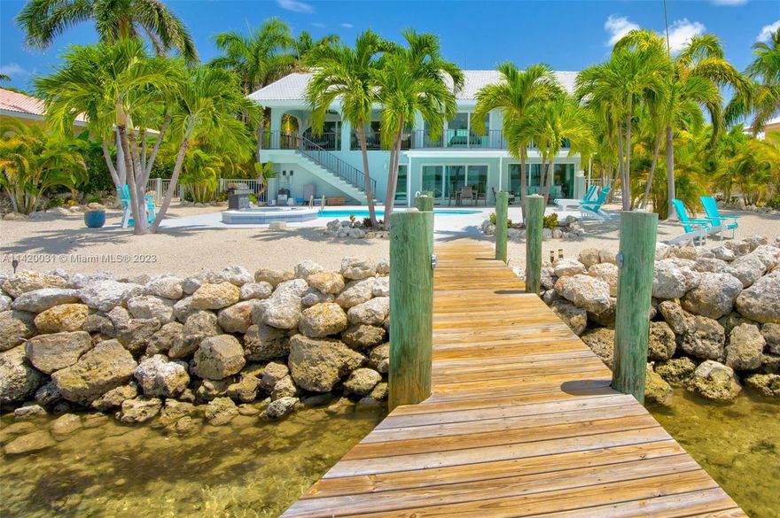 Nestled within the coveted Ocean East peninsula in Marathon, FL, stands an exquisite oceanfront residence that epitomizes luxury living. This premier property is situated on one of the most esteemed and sought-after streets in Marathon, known for its unparalleled allure. This home has undergone extensive updates, including new storm impact windows and doors, a new kitchen, updated bathrooms, flooring, and tasteful furnishings. Capitalizing off this investment is easy; it currently holds a transferable vacation rental license through the City of Marathon and turnkey produces over $200K a year income with heavy owner usage. This makes it an attractive investment opportunity for those interested in vacation rentals.