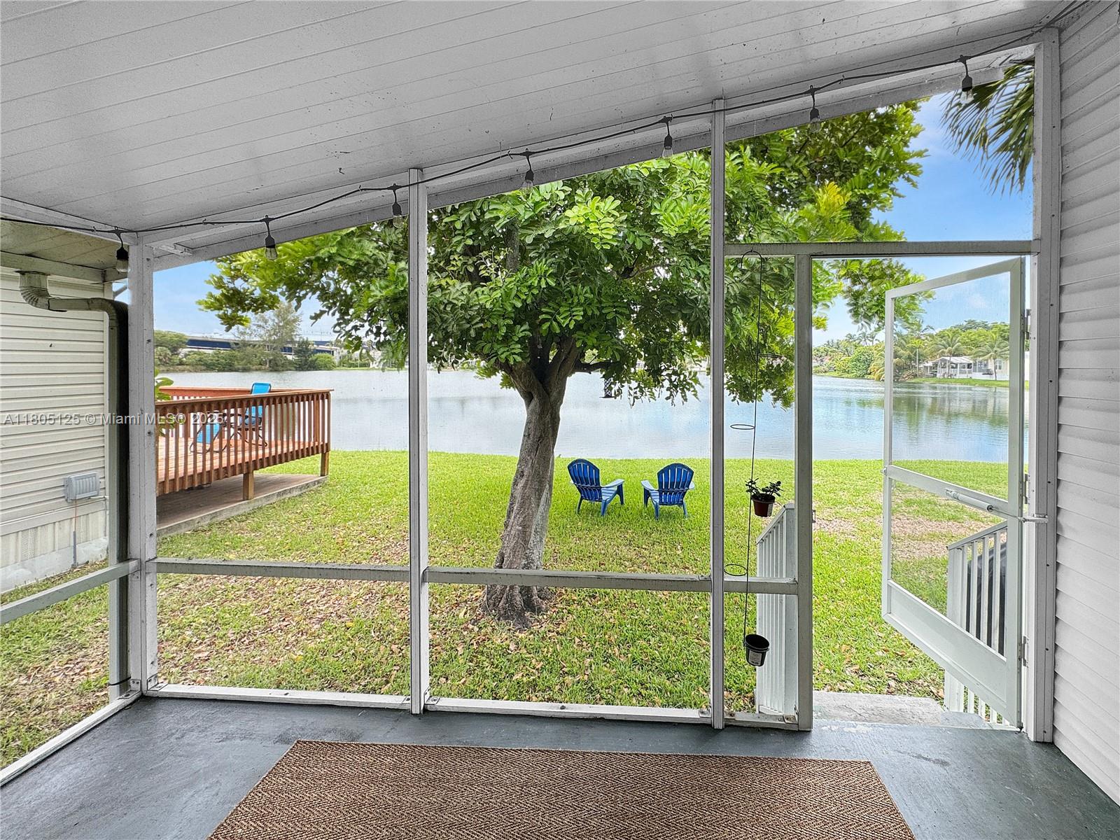 Live where others vacation! This updated 2-bed, 2-bath home in Lauder Lakes (55+) offers serene lake views on both sides. Built in 1998 with 1,050 sq ft, it features 2022 Whirlpool appliances, 2023 wood laminate floors, a refurbished AC and roof (2022), and updated baths. Includes a 2011 Rheem water heater, reliable electric panel, semi-impact windows, hurricane shutters, and a relaxing screened porch. Land lease $1,250/month, guaranteed for 2 years. Association approval required. Seller incentives on full price offers.