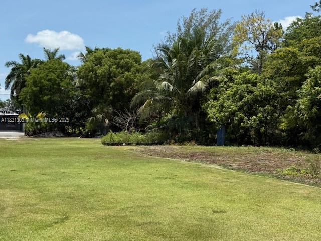 Rare opportunity to own a fully prepped 1.19-acre (51,836 sq ft) residential lot—elevated 1–1.5 ft with over 70 truckloads of fill, offering excellent drainage and no flood risk. This property is cleared, fenced, & completely ready to build. Utilities are in place: electricity through FPL, well water with pump, and plumbing across the lot. Perimeter light posts provide excellent illumination. Features include a tiled outdoor area and a 40-ft container with electrical hookup—buyer may keep. Enjoy over 40 mature fruit trees including mango, lychee, avocado, banana, coconut, star fruit, plum, and soursop. A lien search was completed within the past year and confirms the property is free and clear. Whether building a dream home or investing in land with utilities and infrastructure in place.