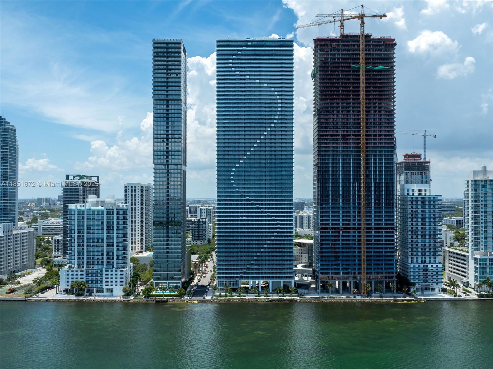 Introducing a brand-new luxury condo in the iconic Aria Reserve with Stunning Panoramic Biscayne Bay Views! Never-lived-in 3-bedroom, 3.5-bathroom condo boasts an elegant modern design, expansive living areas, and breathtaking views of the city and bay. Situated in a 5-star waterfront location, Aria Reserve redefines resort-style living with its world-class amenities, including a private sports marina, spa, tennis, paddleball, and squash courts, basketball, mini golf, and a private dog park. Residents can enjoy two swimming pools with water views, a semi-Olympic pool with practice lanes, along with a library, lounge, and meeting rooms—a true lifestyle destination in the heart of Miami.