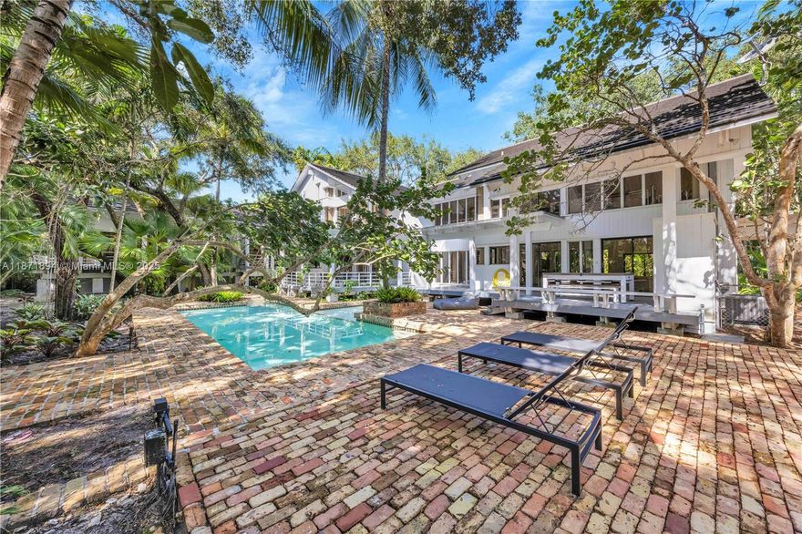 Commanding a privileged location within the prestigious gated community of Snapper Creek Oaks this unique home designed by John Weller encompasses approximately 5,600 sf of generously scaled interiors.  Stunning living room with walls of glass & soaring open-beamed ceilings and coral rock fireplace, formal dining room, charming kitchen with adjacent breakfast area and spacious pantry spaces.  Three bedrooms occupy the west wing while the tranquil main suite and loft area are privately nestled on the second floor.  Open decks and covered patios surround the beautiful pool area and lush grounds. Beautifully updated baths, laundry room, and spacious 2-car garage complete this idyllic "tree house".