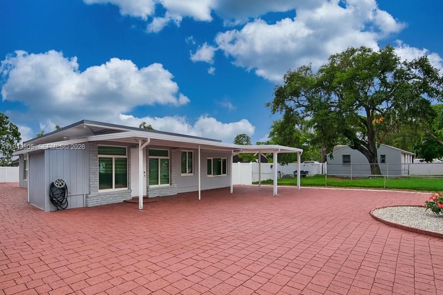 Rare opportunity in Hollywood! This unique property features 3 bedrooms, 3 bathrooms, and 3 kitchens — ideal for multi-generational living or flexible use. Fully updated and move-in ready with impact windows throughout, new paver driveway, aluminum carport, and a large backyard completely covered in pavers for zero maintenance. New fence, outdoor laundry area with new washer and dryer, 2 storage units included, fresh exterior paint, and updated electrical, plumbing. Conveniently located near Florida Turnpike with easy access to shops, restaurants, and major highways. No HOA. Owner is motivated. Priced to sell.