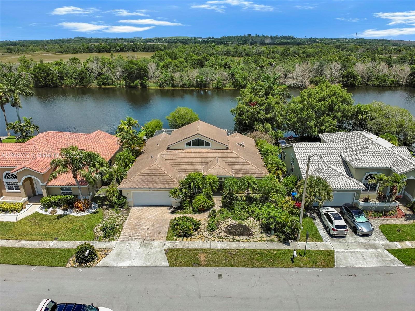 Spacious 4 BED / 2 BATH home with a 2 car garage, pool and private water view. The open floor plan connects the living spaces seamlessly, while the backyard offers a serene water view—perfect for quiet evenings or entertaining. The screened-in patio and pool area provide a perfect spot for relaxing. This is the perfect blend of livable today and full of potential for tomorrow. Needs TLC