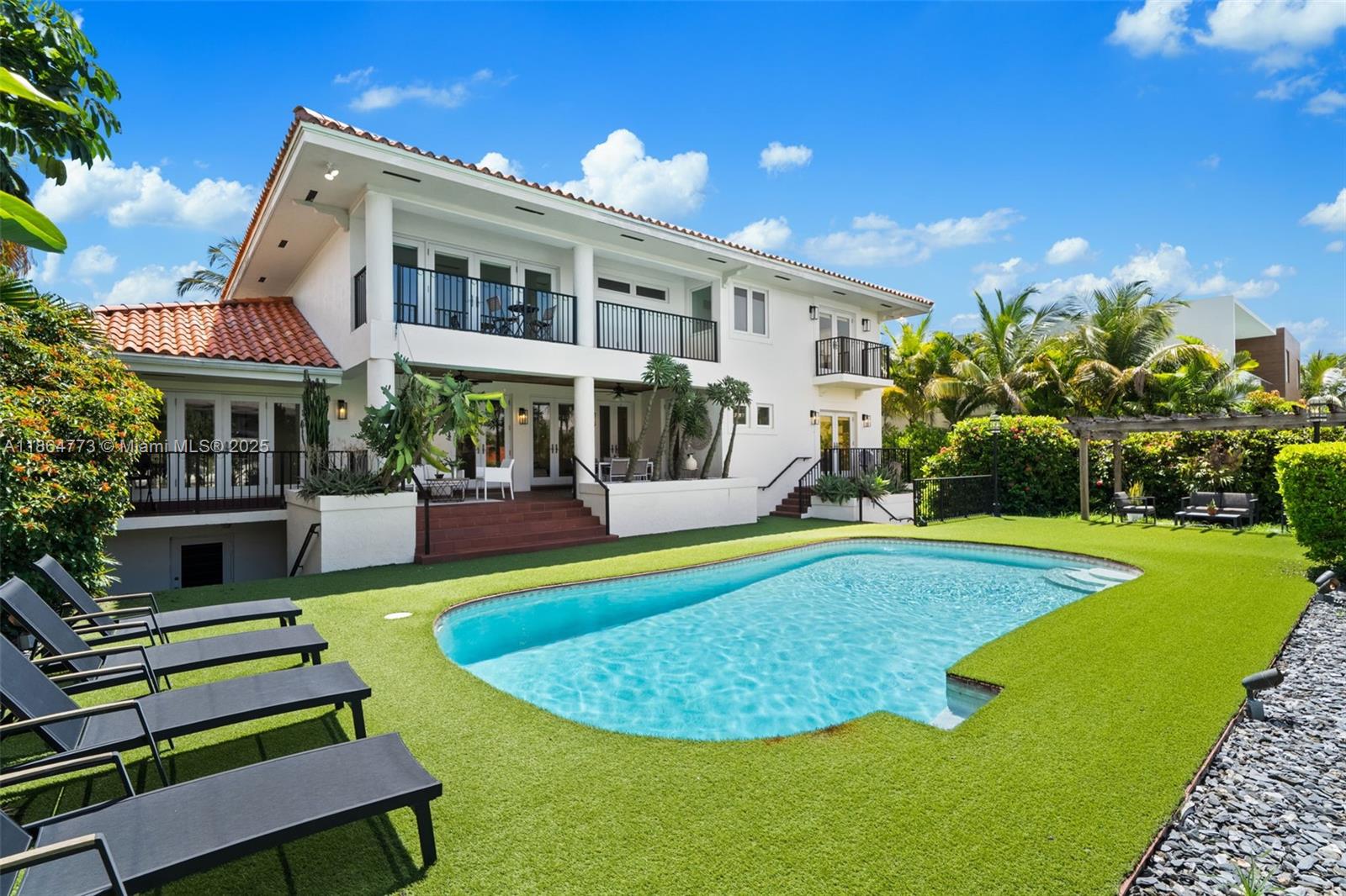Exquisite Waterfront Living in Sunrise Harbour. Highly sought-after, guard-gated community which boasts direct ocean access to the bay, a gem for boating enthusiasts. With a grand circular driveway, step into a double-height living room flooded with natural light. First floor has living room, family room and 2 bedrooms. The home’s serene outdoors are perfect for elegant entertaining. Upstairs, the expansive primary suite features its own waterfront balcony. The lower level offers a 4-car garage with storage, playroom, full bath, and two additional guest suites opening to the patio. Custom closets and a sleek new chef’s kitchen, this residence is truly move-in ready. Perfectly positioned near Miami’s top schools, parks, and world-class amenities. A Beautiful Miami Home! Make It Rein!