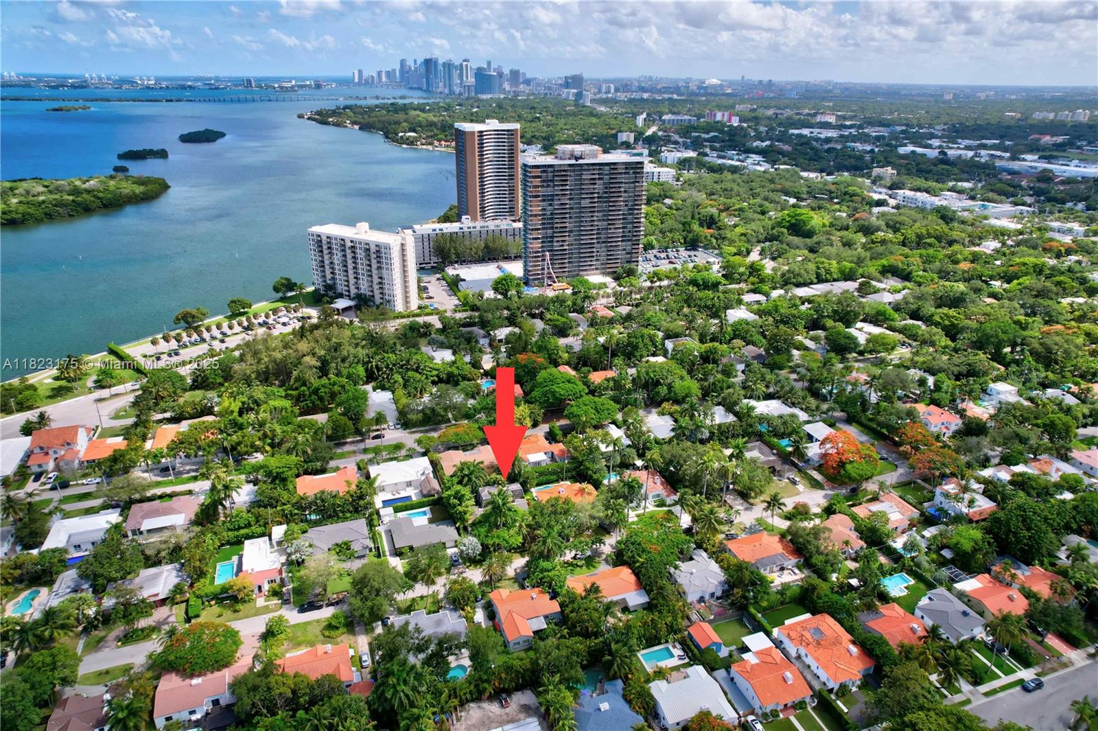Nestled in the heart of the coveted Bayside Historic District, this two-story home offers 2,465 square feet of interior living space on a lush 7,500 square foot lot. Located just steps from Baywood Park, where residents enjoy morning strolls and sunset views over Biscayne Bay, this property sits in one of Miami’s most tranquil and tree-lined neighborhoods. Secure and rich in architectural charm neighborhood. This residence presents a rare opportunity to renovate or rebuild in a serene setting just minutes from the Design District, MiMo, and Downtown Miami. With a spacious footprint, mature tropical landscaping, and an unbeatable location near the bay, this property is ideal for developers, visionaries, or end-users ready to create their dream home. Sold AS IS.
