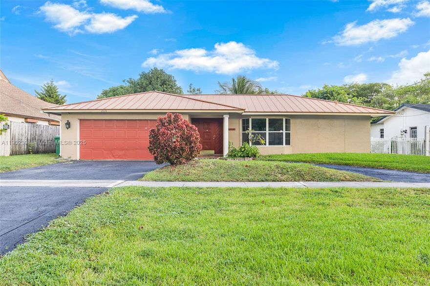 Charming 3-bedroom home featuring a durable metal roof, inviting bay window, and spacious circular driveway leading to a 2-car garage. The split floor plan offers privacy, with the master suite separated from the other bedrooms. Enjoy peaceful canal views from the backyard, perfect for relaxing or entertaining. A comfortable and well-designed home blending charm, functionality, and serene waterfront living. Home offers flexible spaces that can easily adapt to your lifestyle and create a personalized living experience.