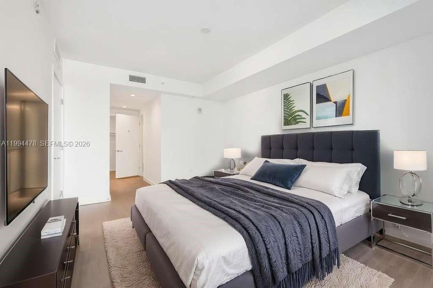 Luxury living in Bay Harbor Islands. Bright and spacious residence in a boutique waterfront building, just minutes from Bal Harbour Shops, beaches, dining, and top-rated schools. This rare 1BR/1.5BA offers 1,125 SF interior + 473 SF exterior, highlighted by an oversized terrace for exceptional indoor-outdoor living. The layout offers exceptional storage rarely found in a 1-bedroom, including 3 closets in the primary bedroom, an oversized laundry closet, and a large additional exterior storage closet on the terrace. Owner is currently completing custom closet build-outs, upgraded lighting fixtures, and window shades throughout. Offered furnished, with short-term rentals welcome, 6-month minimum.

Residents enjoy a full-service lifestyle with 24-hour valet and concierge, a rooftop pool and hot tub, fully equipped gym, and beautifully designed club room with lounge seating and TV. The rooftop offers 360-degree views of Miami and serves as an exceptional space for entertaining, featuring a summer kitchen and BBQ area. A true five-star living experience with resort-style amenities and stunning nighttime views.