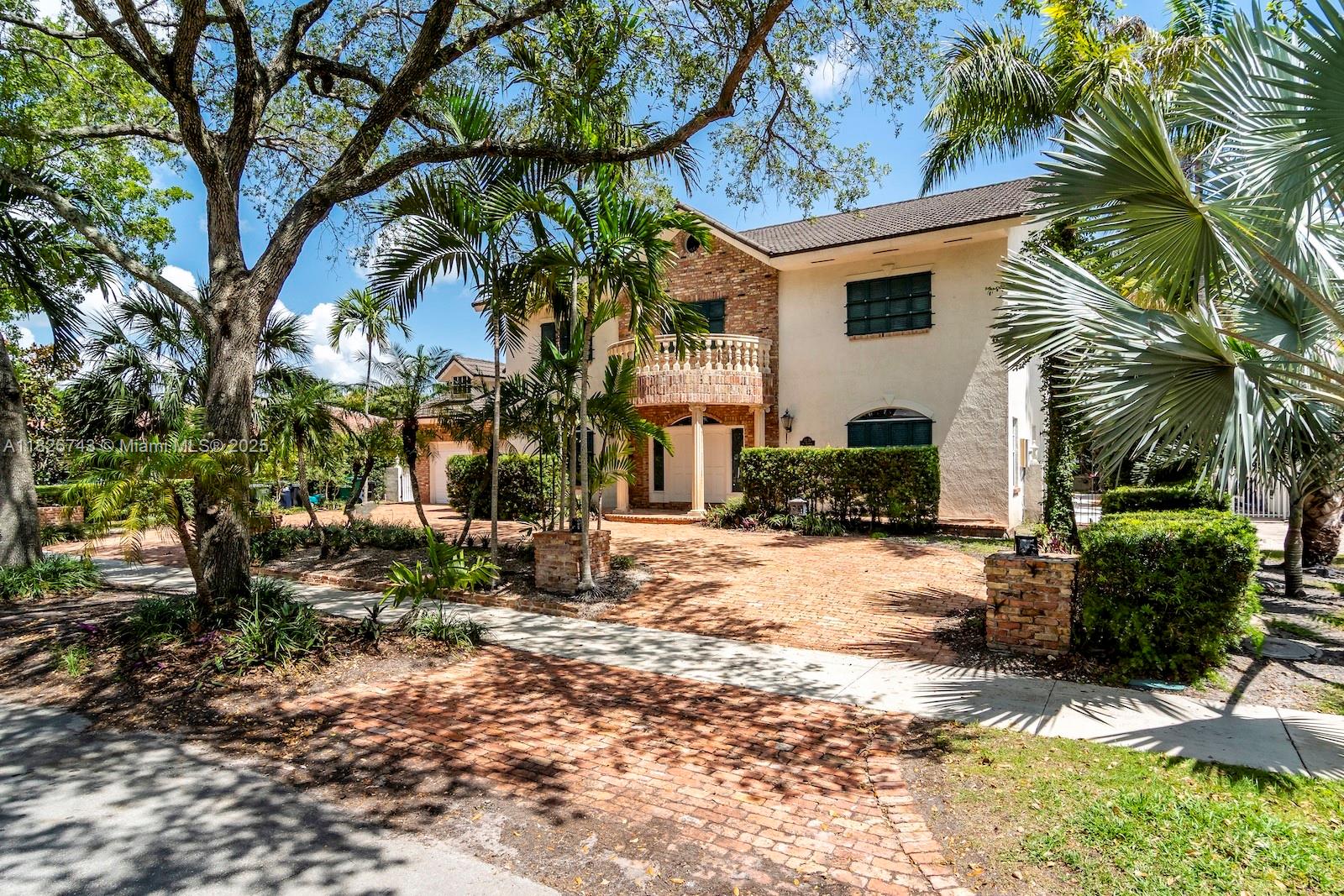 This home's timeless architectural design commands attention with its Old Chicago brick, stately façade with classic shutters, and its columned portico that speaks to its Southern charm. Nested in the prestigious guard-gated Loch Lomond community, this beautifully designed two-story estate home offers over 5,204 sqft of living space with thoughtful details throughout. A dramatic staircase welcomes you inside, where a floor-to-ceiling Old Chicago brick fireplace anchors the living room and extends into the upstairs primary suite. Additional highlights include an open kitchen, a formal dining room, spacious family room, and secondary primary guest suite on the first floor. Enjoy a resort-style pool, spa, and covered veranda. Two-car garage and 13-year-old metal roof.