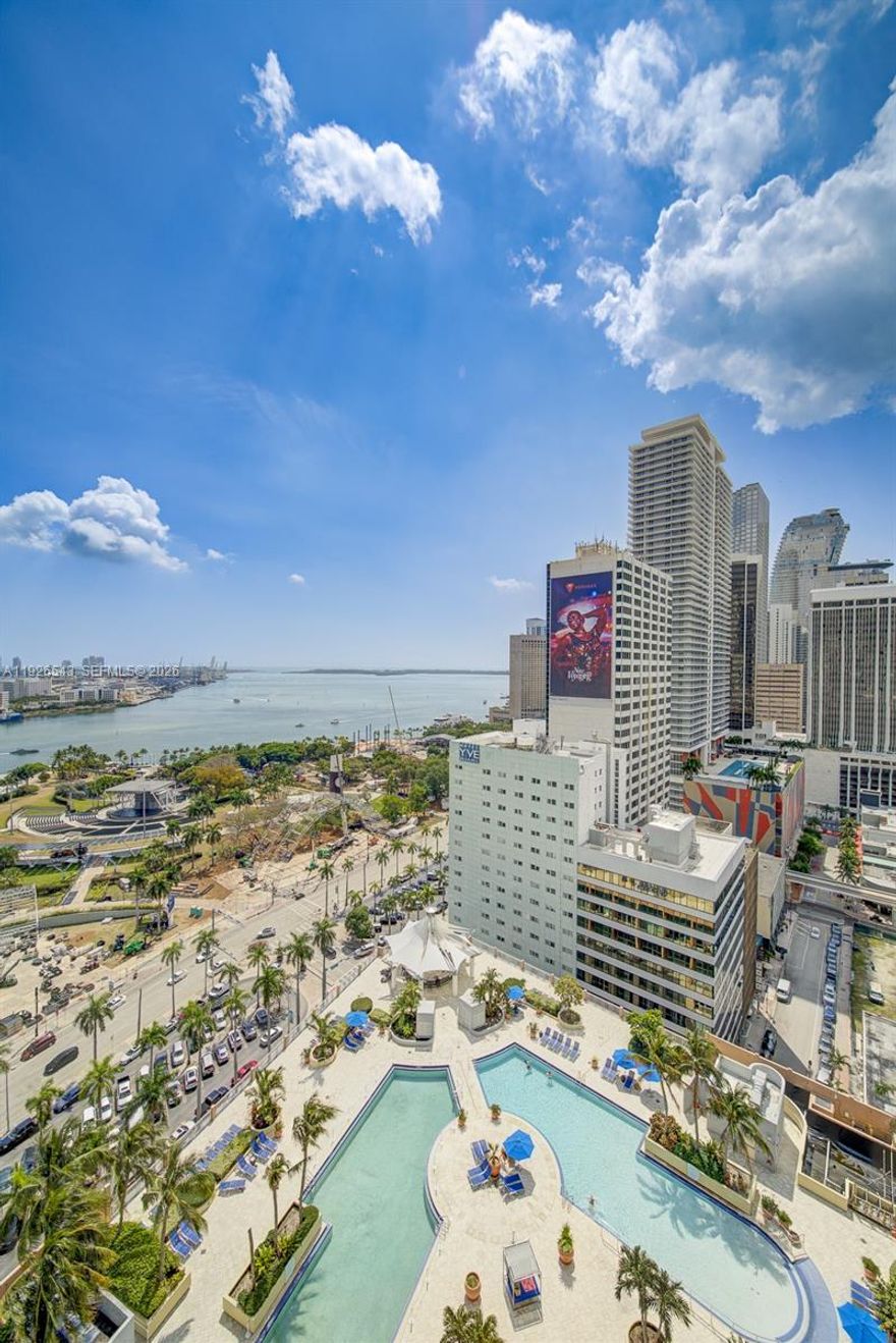 Prime location! Waterfront Luxury building across from Miami largest Bayfront Park. Fully furnished with  beautiful bay and Ocean views in this 2-bed, 2-bath corner unit featuring stainless steel appliances, black granite countertops, and an in-unit washer/dryer. Enjoy the balcony with unblocked views of Downtown Miami and Biscayne Bay. Steps away from Museum Park, the Adrienne Arsht Center, Perez Art Museum, Frost Museum of Science, cruise ships, Miami Dade College, Metro Mover, Brightline train station, and Whole Foods. A 15-minute walk to the Brickell area. This resort-style building offers 24-hour concierge, 4 pools with service, a gym, spa, movie theater, and more. It's walking distance to restaurants, shopping, entertainment, and nightlife. The expressways to the beaches and airport are just blocks away.