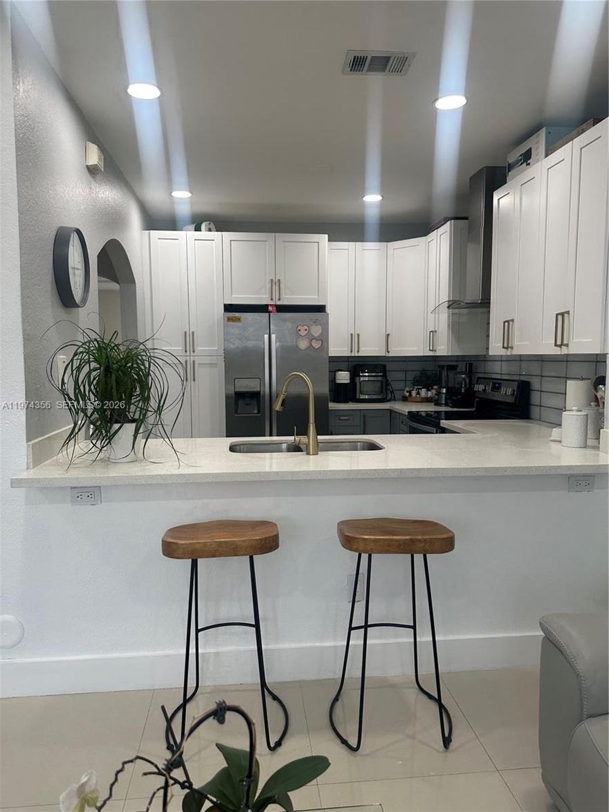 Beautiful updated 3-bedroom, 2.5-bathroom townhome located in the gated community of Villas at Nautica in desirable West Miramar. This move-in ready residence has freshly painted interiors, modern light fixtures, stylish window shades and neutral finishes throughout. Ceramic Flooring enhances the first level.

The remodeled kitchen showcases quartz countertops and modern backsplash, while all 3 bathroom have been tastefully updated. 

Step outside to a private patio with low-maintenance artificial turf, perfect for BBQs and outdoor entertaining. Two assigned parking spaces are conveniently located right in front of the unit.

The HOA includes exterior building insurance, roof maintenance (new roof currently being installed), fence replacement, common area maintenance, amenities and trash service.