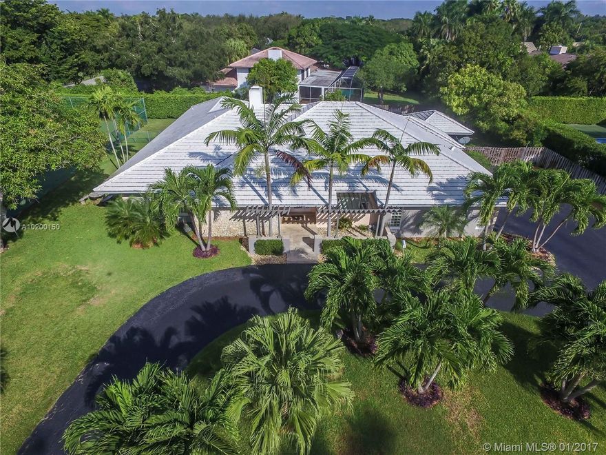 Tennis Anyone?  Updated Bright Open Hollub Built complete with N/S Tennis Court. Modernized in 2006 Re-roofed in 2014, This open floor plan is ideal for the entire family. Foyer Entry to long views of extra deep roofed & screened pool patio.  Two Mstr Bdrs in this split plan. Semi Detached Bonus Room is Ideal for Office, Yoga, Gst Suite etc. The Entertainers Kit  works well with the Vaulted Ceiling Fam. Room anchored by Cozy Fireplace.  Formal D/R being used as office, Move in Condition. Easy to Show