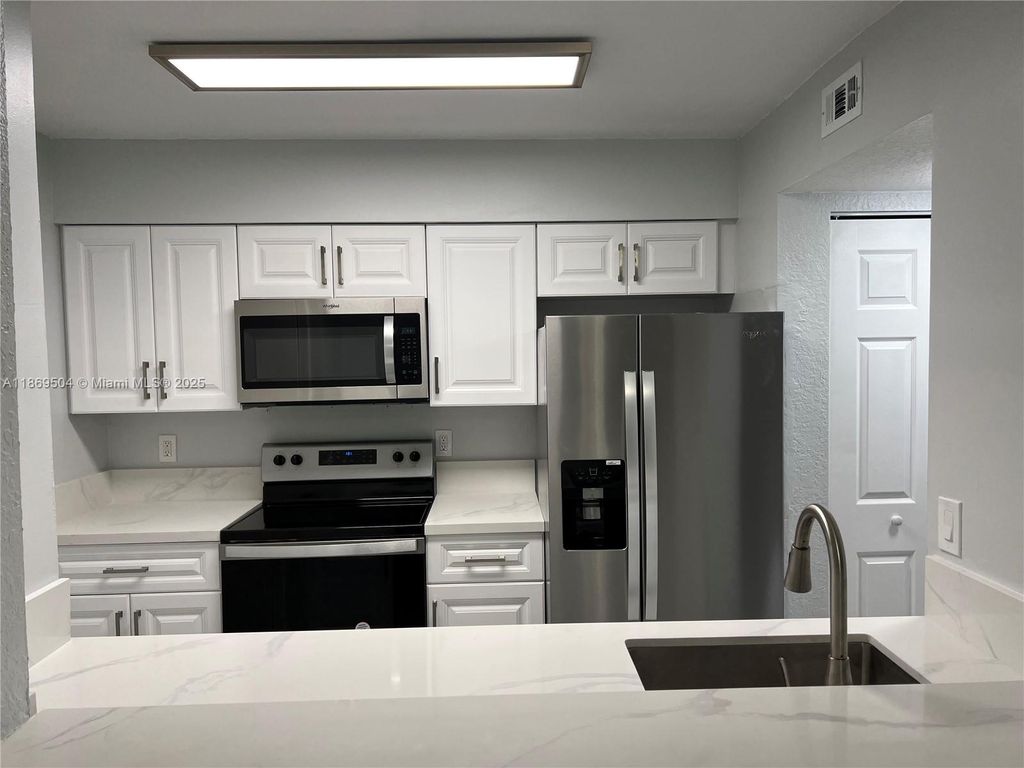 Photo of 2871 N Oakland Forest Dr #102, Oakland Park, FL 33309 (MLS # A11869504)