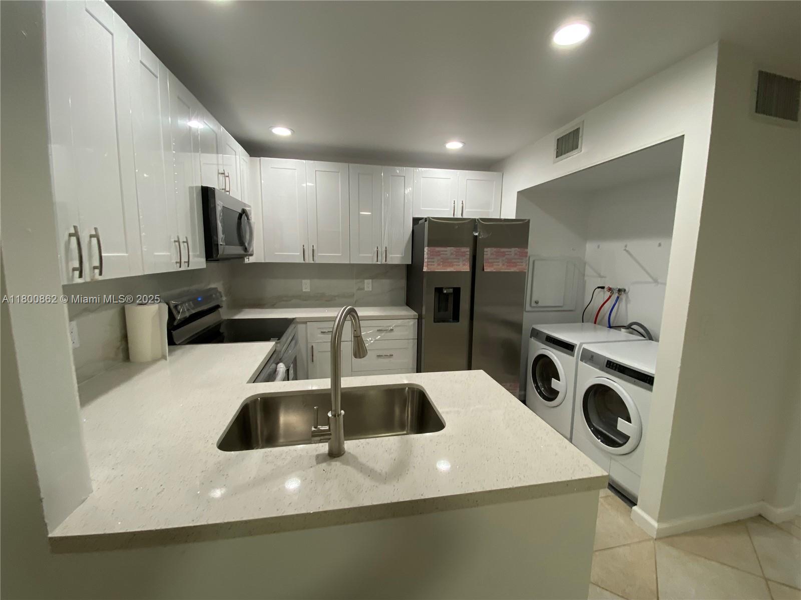 Move-in ready townhouse in Palm Beach Gardens. Two-story townhome features 2 bedrooms and 1 full bath upstairs plus 1 half bath on the first floor. Corner townhouse with privacy fence, private entrance with a nice garden and yard. 2 Parking spaces in front. Enjoy the screened patio, brand new kitchen with granite countertops, stainless steel appliances and a spacious living area with a charming fireplace. Modern bathrooms, tile flooring downstairs, recent A/C, 2025 new roof is been installed. Minutes from schools, medical services, daily essentials and commuter routes. Seller is offering $5,000 credit to the buyer at closing with full-price offer for closing costs or interest rate buy-down. 2 pets up to 40 pounds each allowed. No rental restrictions.