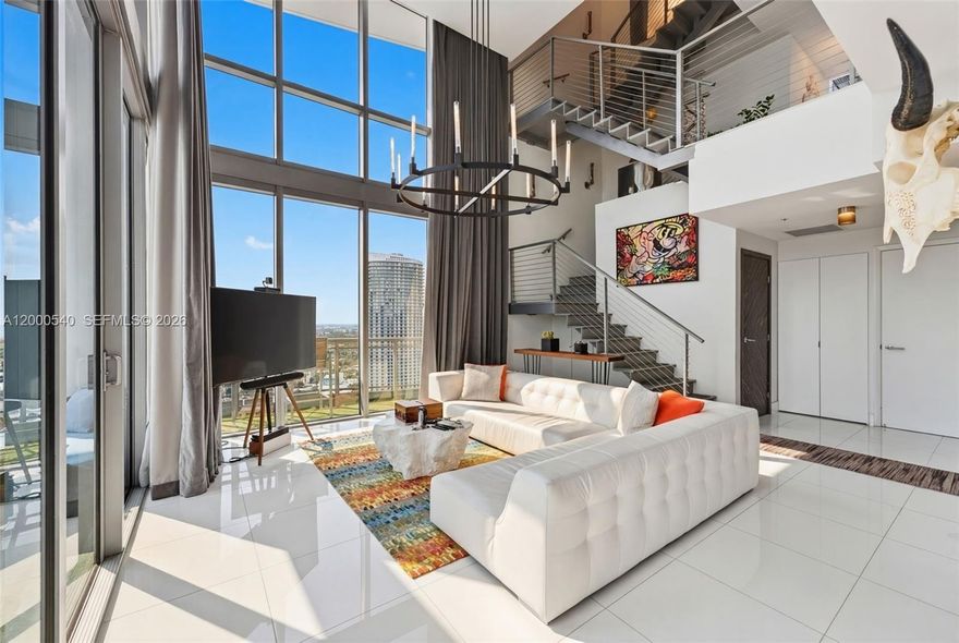 Perched high above the skyline at 90 SW 3rd Street, PH-12 in Miami, this one-of-a-kind three-story penthouse offers an unmatched blend of luxury, space, and breathtaking design. As the largest residence at Riverfront, the home spans approximately 4,500 total square feet, including an extraordinary 2,000 sq. ft. private rooftop terrace complete with a pool and jacuzzi—perfect for enjoying sweeping 360-degree views of the city and river.

Inside, the dramatic living room showcases soaring 20-foot ceilings, creating a bright and open atmosphere ideal for both relaxing and entertaining. The oversized primary suite is a true retreat, featuring motorized curtains and a custom marble bathroom with a spacious soaking tub and separate shower.

The second bedroom is currently unfurnished, offering flexibility to be customized by either the owner or tenant. The third bedroom has been thoughtfully designed as a state-of-the-art home fitness center. This exceptional penthouse is available furnished for an annual lease, delivering a rare opportunity to experience elevated Miami living at its finest.